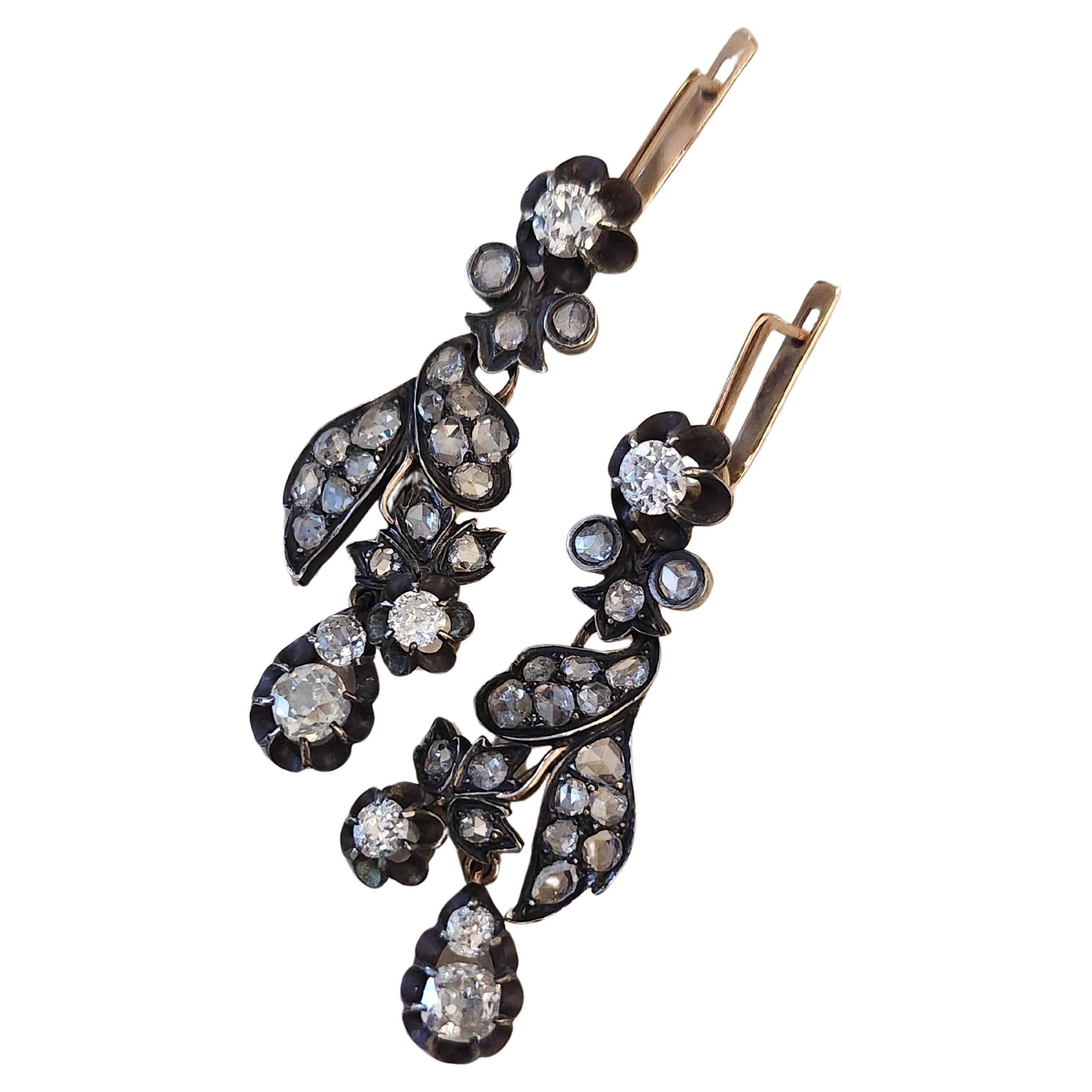 14k gold large earrings in oxdized gold color in leaf designe with old mine cut diamonds and rose cut diamonds estimate weight of 3.5 carats total lenght 7cm 