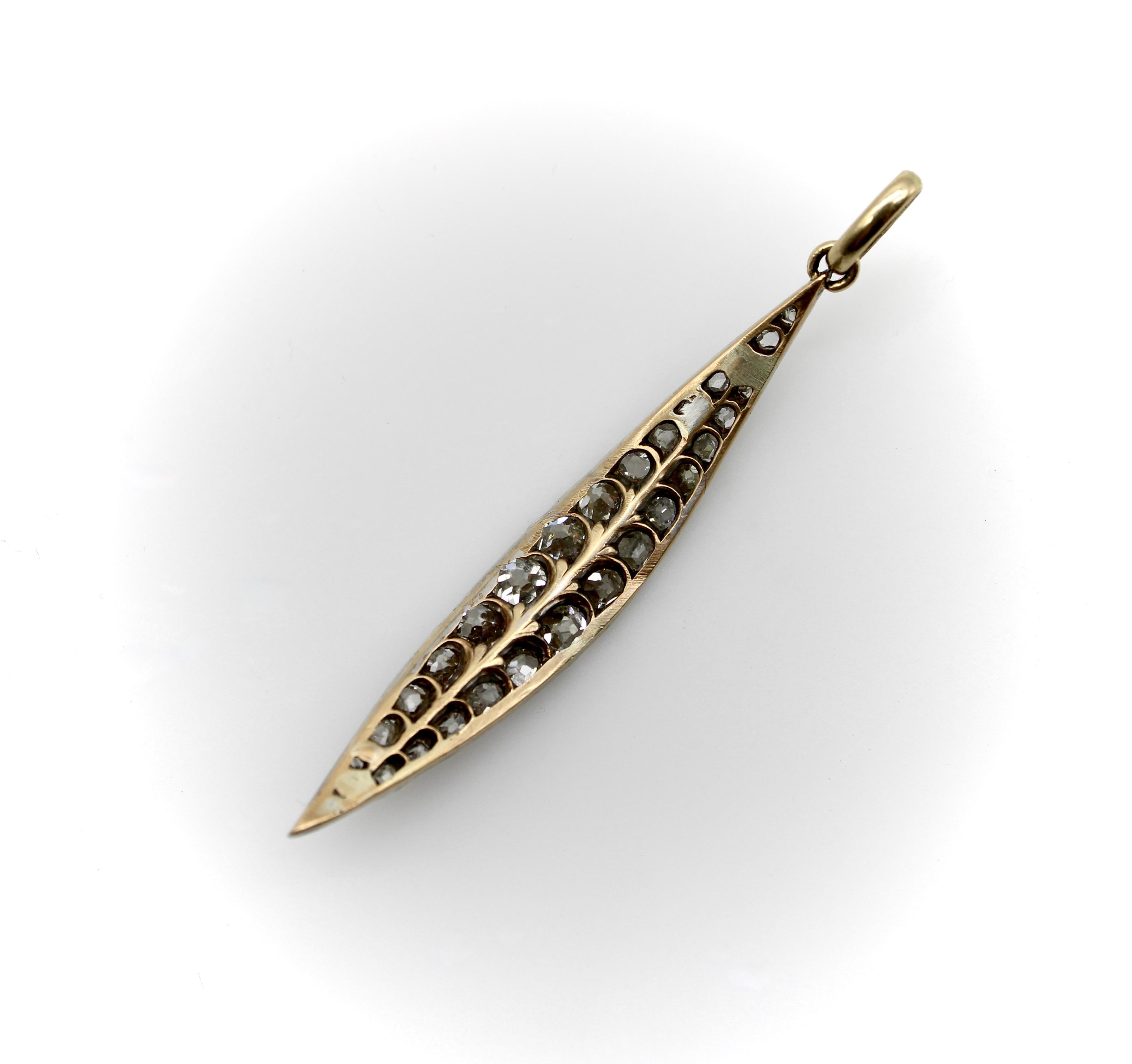 This extraordinary leaf-shaped pendant is studded with gorgeous chunky Old Mine Cut diamonds. We believe this was once part of a tiara and was most likely the shape that adorned the headless. We added an ample size 14k gold bail so that it could be