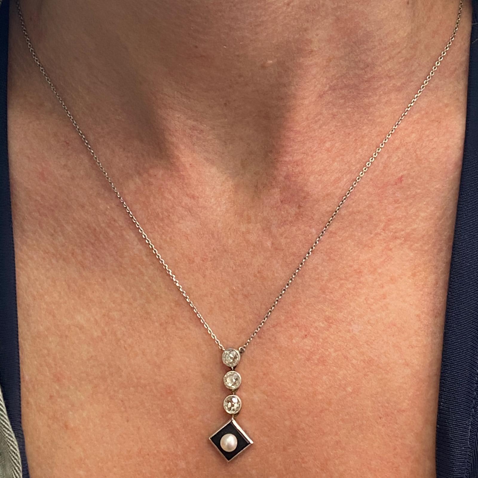 Original antique three diamond drop pendant handcrafted in platinum and 14 karat gold. The pendant features three Old Mine Cut Diamonds weighing approximately 1.00 carat total weight and graded J-K color and SI clarity. The square shape bottom drop