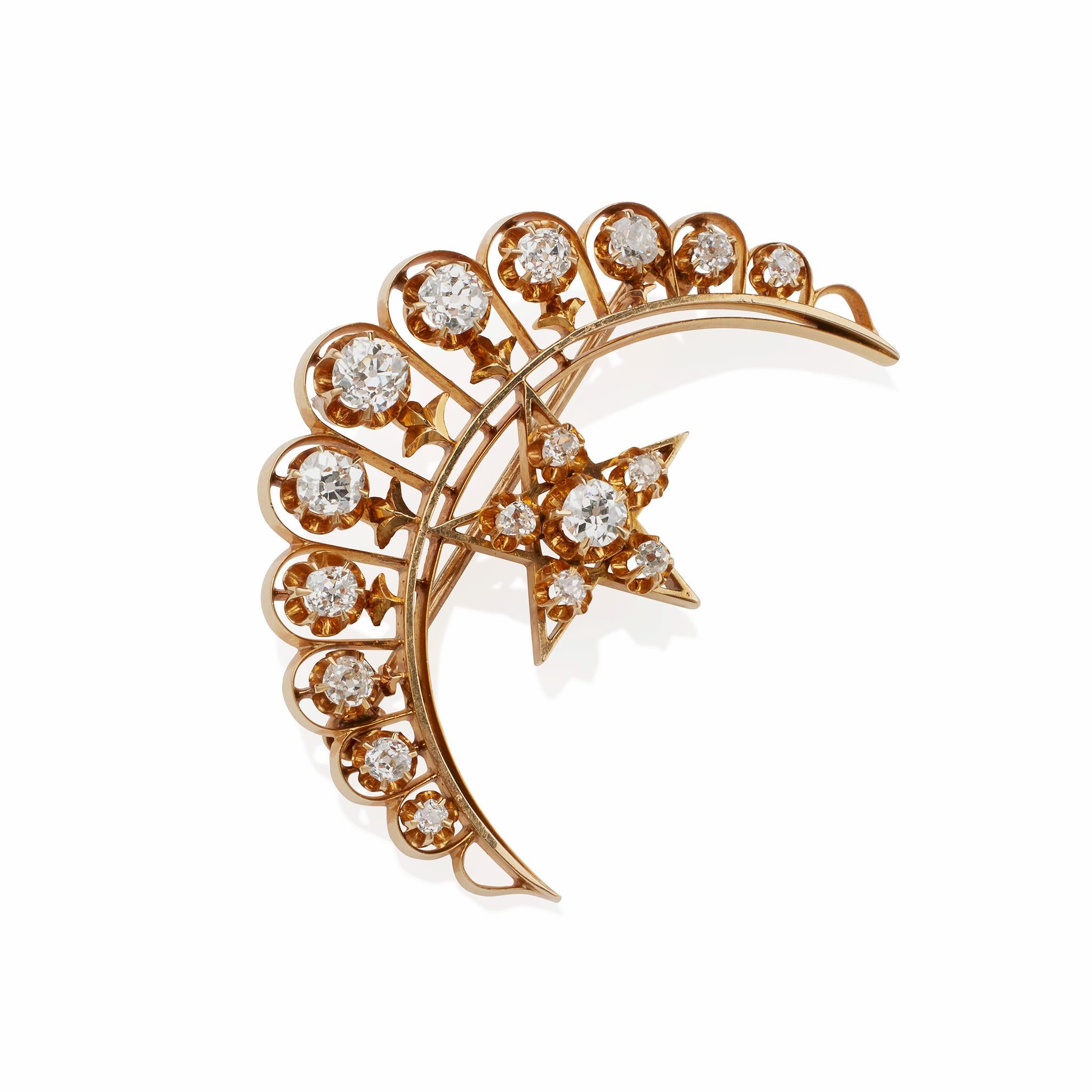 Created in the last years of the 19th century, this crescent and star brooch iin 18K gold s set with almost 2.50 carats of diamonds. The slender crecent is set with eleven graduating old mine-cut diamonds, off-set by a fice-pointed star set with six