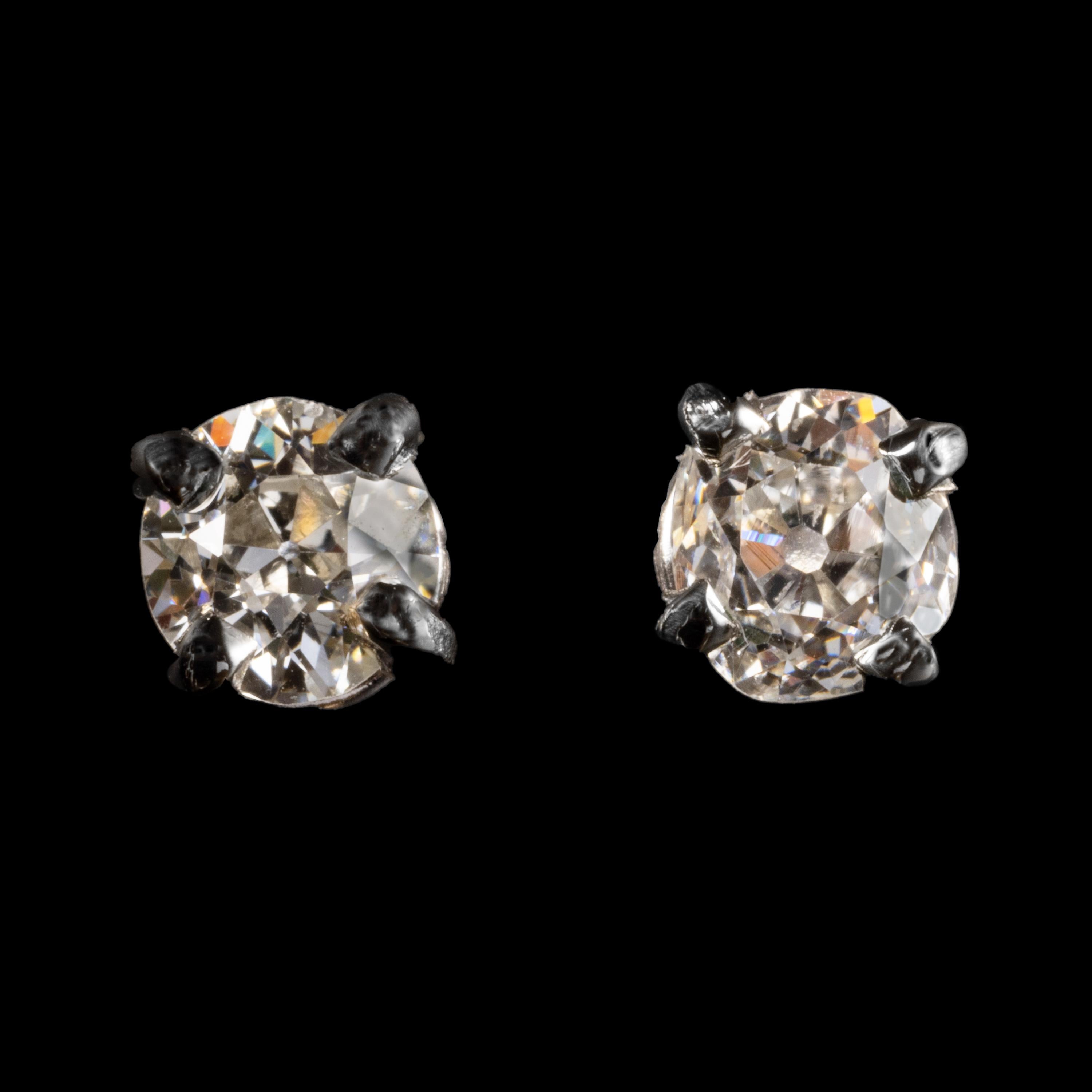 So simple yet so elusive: stud earrings featuring antique old-mine diamonds. This lovely pair features two well-marched old-mine diamonds that are bright and near-colorless (G/I) and quite clean (VS2/SI1). They are filled with fire and each was