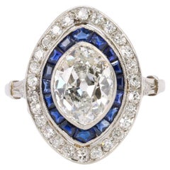 Old mine cut marquise diamond 2.1 ct Art Deco ring set with calibrated sapphires