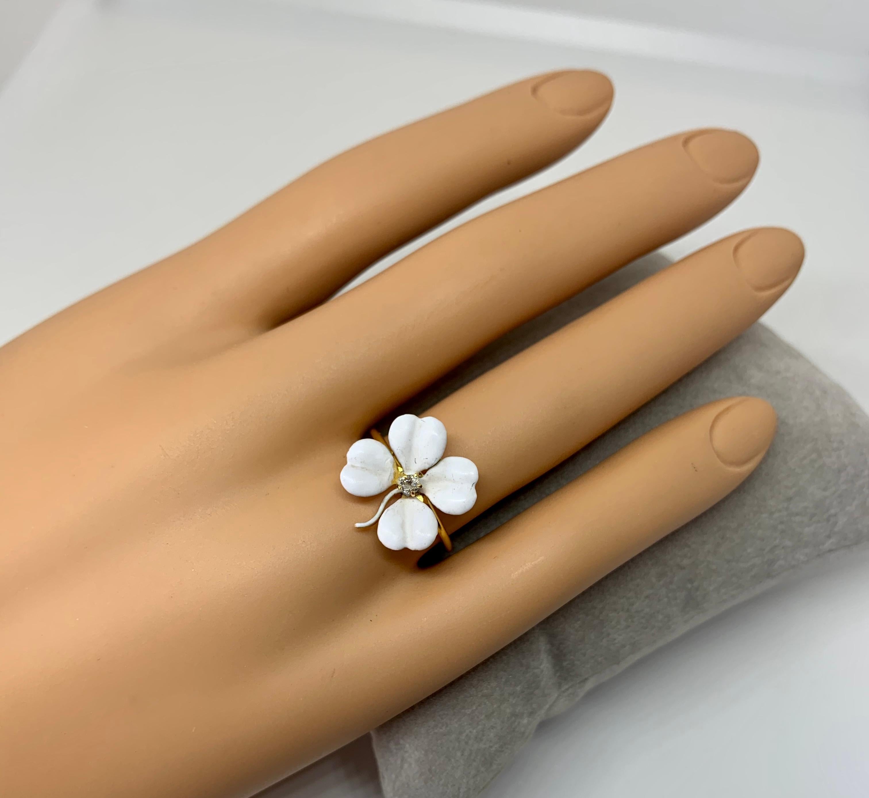 This is a very special antique Victorian - Edwardian Ring in the form of a Four Leaf Clover Flower in gorgeous white enamel with a central antique Old Mine Cut Diamond.  The beautiful clover flower is done with exquisite enamel work and in an
