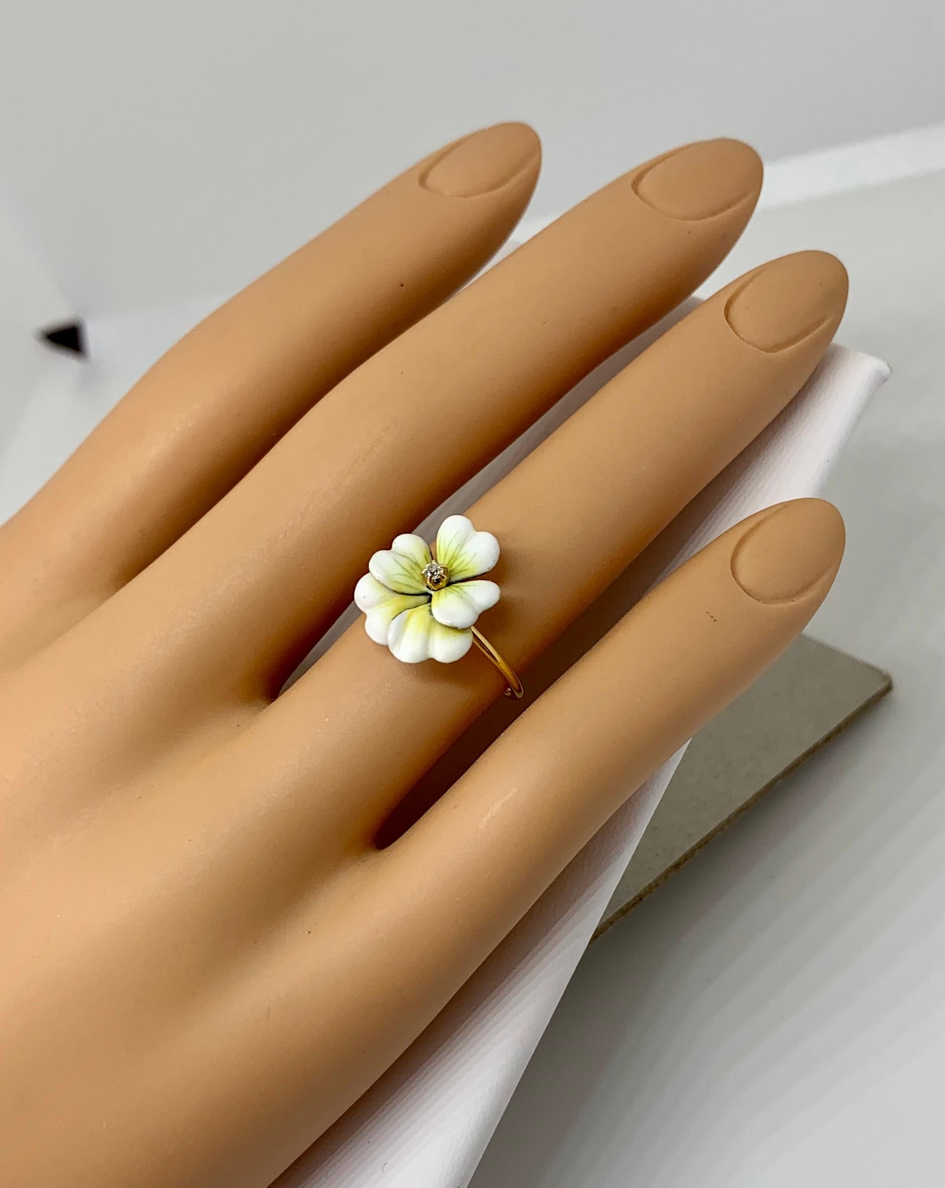 This is a very special antique Victorian - Edwardian Ring in the form of a double Pansy Flower in gorgeous white and pale green enamel with a central antique Old Mine Cut Diamond.  The beautiful double pansy flower is rare and is done with exquisite