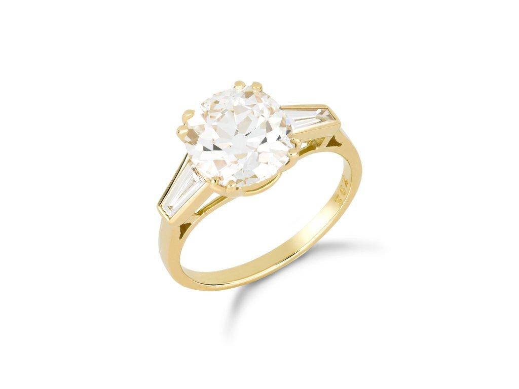Old mine diamond flanked solitaire ring. Set to centre with cushion shape old mine diamond, G colour, SI1 clarity with a weight of 3.01 carats in an open back claw setting, flanked by two tapered baguette cut diamonds in open back rubover settings