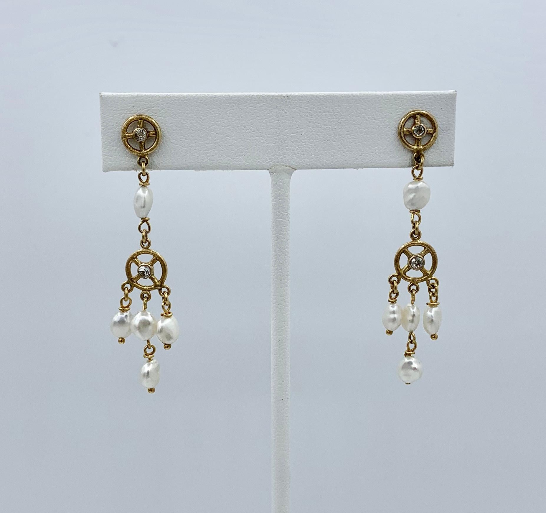 This is a delightful pair of Dangle Drop Earrings Old Mine Diamonds and Pearls set in 14 Karat Yellow Gold.  The festive jewels are perfect for everyday or the most glamorous affair.  I love that these earrings have Old Mine Cut Diamonds. 
The