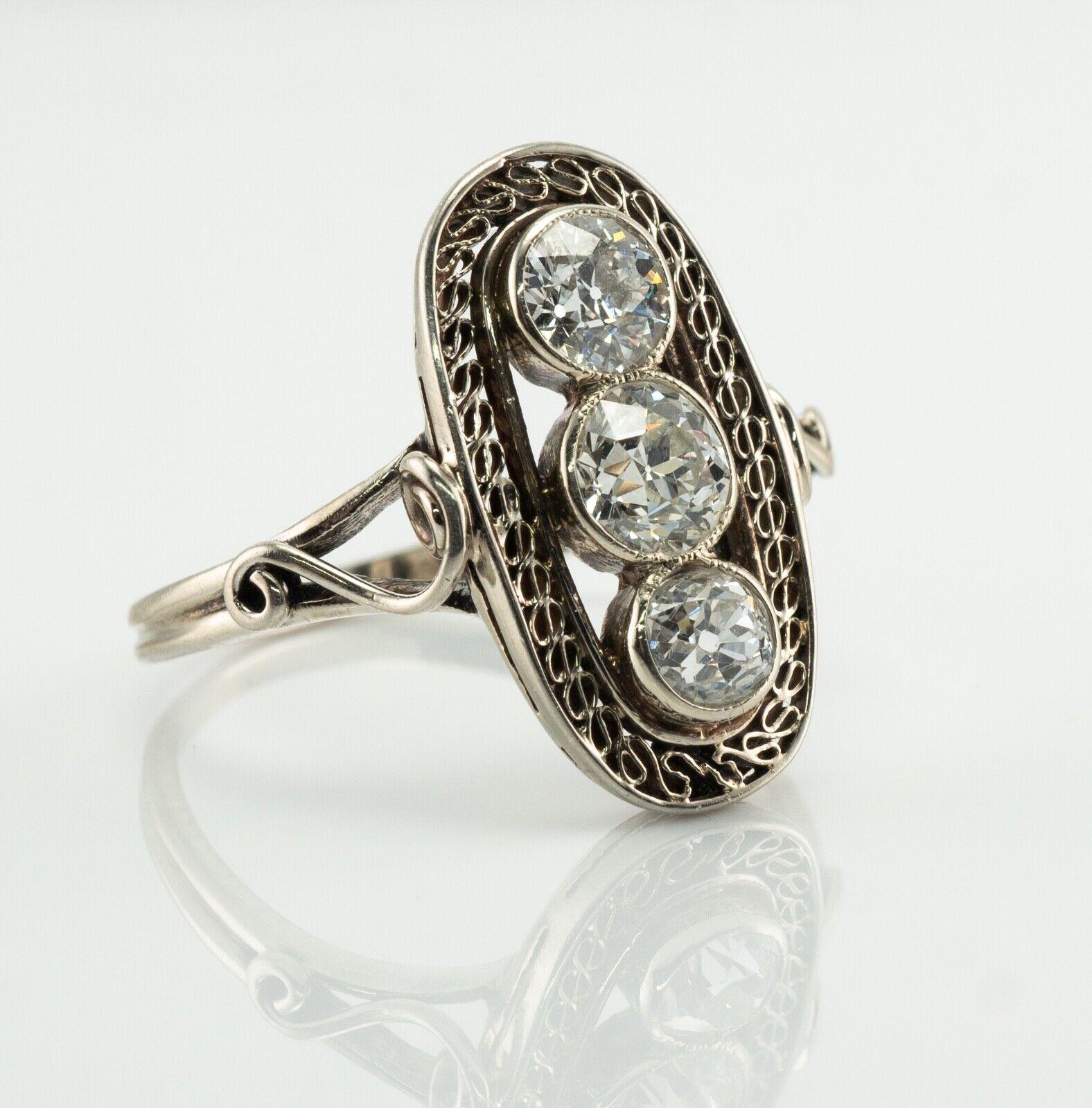 This vintage circa 1920s ring is crafted in solid 14K White Gold (carefully tested and guaranteed). Three old mine cut diamonds total 1.30 carats; the center diamond is .50 carat and two diamonds are .40 carat each. They are VS2 clarity and H color.