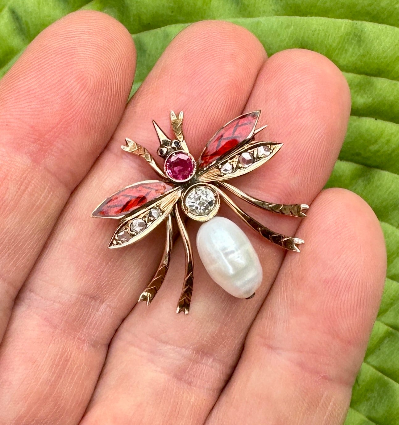 This is a stunning antique Art Nouveau - Art Deco Enamel, Rose Cut and Old MIne Cut Diamond, Ruby, Sapphire and Pearl Fly Bug Insect Brooch Pin in 10 Karat Gold.  The magnificent insect brooch has a central 1/2 Carat Old Mine Cut Diamond of great