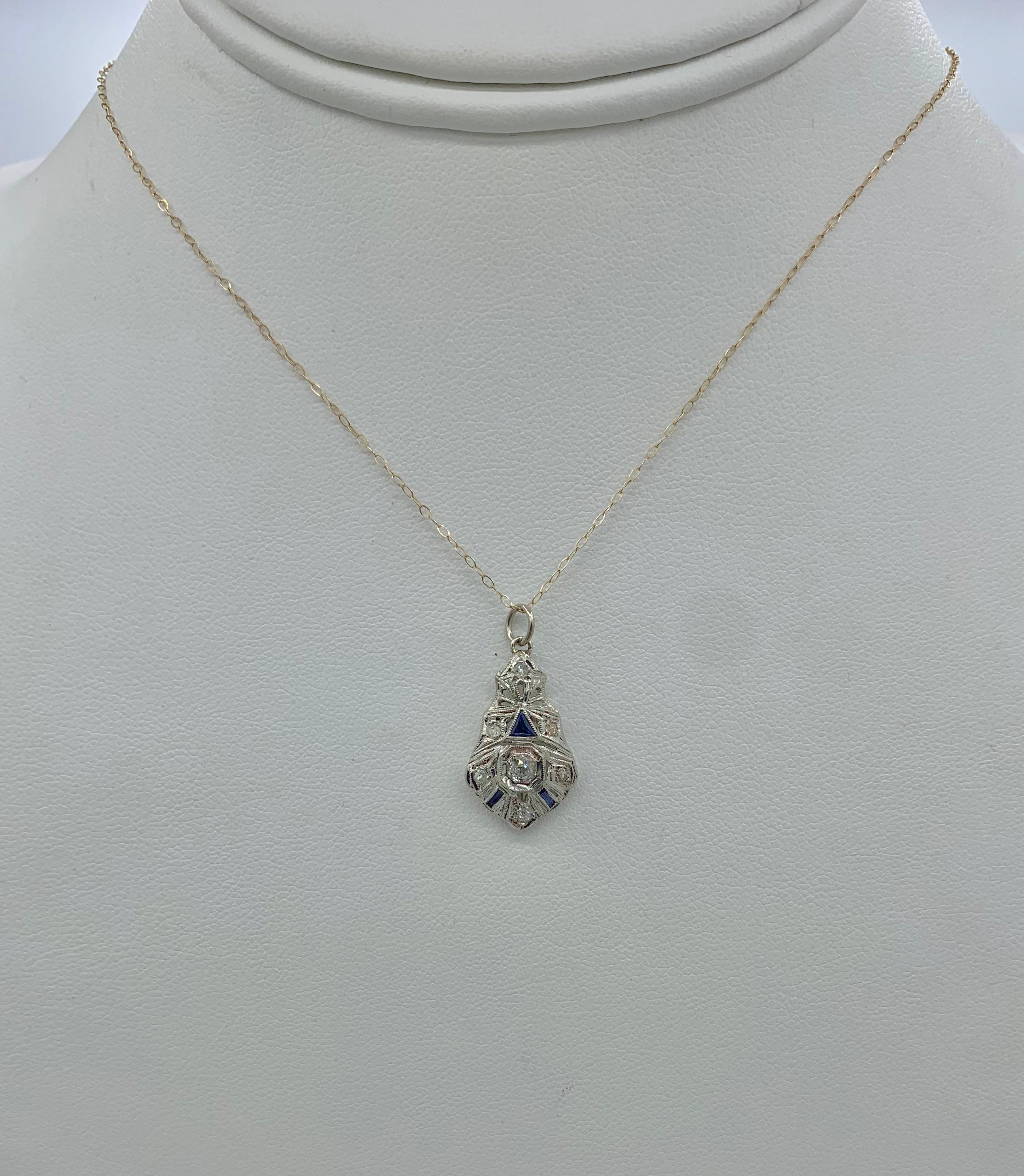 A stunning antique Art Deco - Victorian - Edwardian Diamond Sapphire Lavaliere Pendant in 18 Karat White Gold.  The beautiful pendant has a central sparkling white old mine cut diamond of approximately .15 Carats.  This is surrounded by six