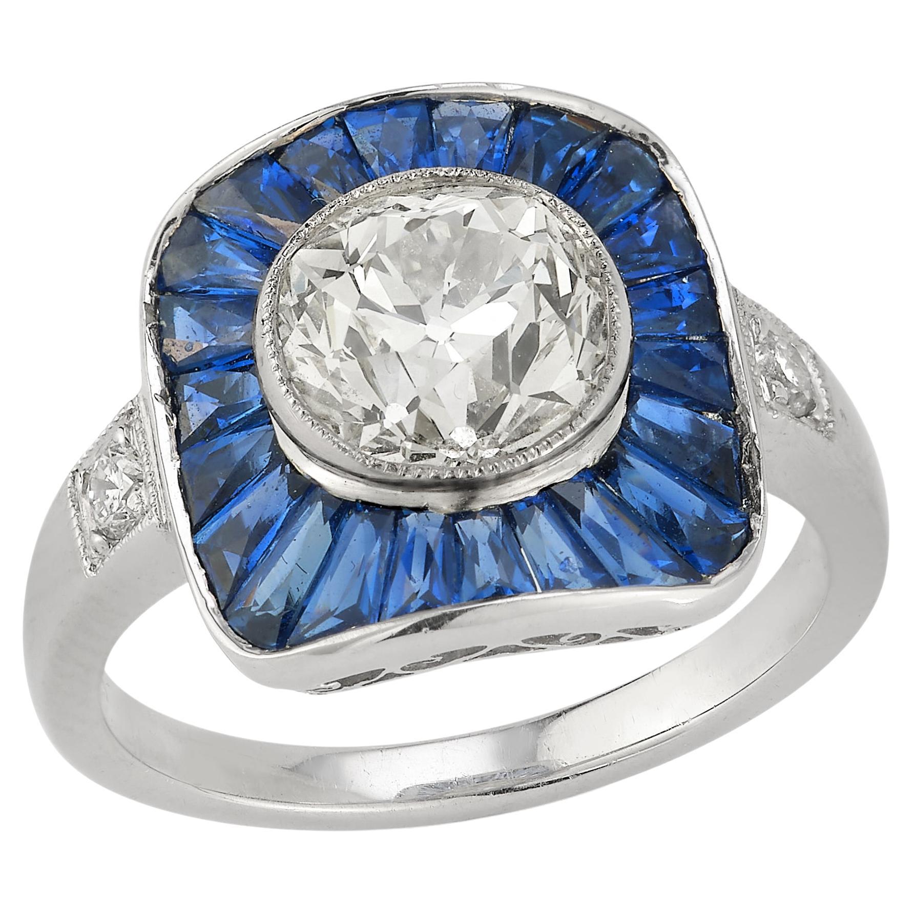 Old Mine Diamond & Sapphire Target Ring

1 central approximately 2.16 carats old mind diamond framed by 22 sapphires weighing approximately 1.61 carats, with 2 round diamonds weighing approximately .010 carats all set in a platinum ring

Ring Size: