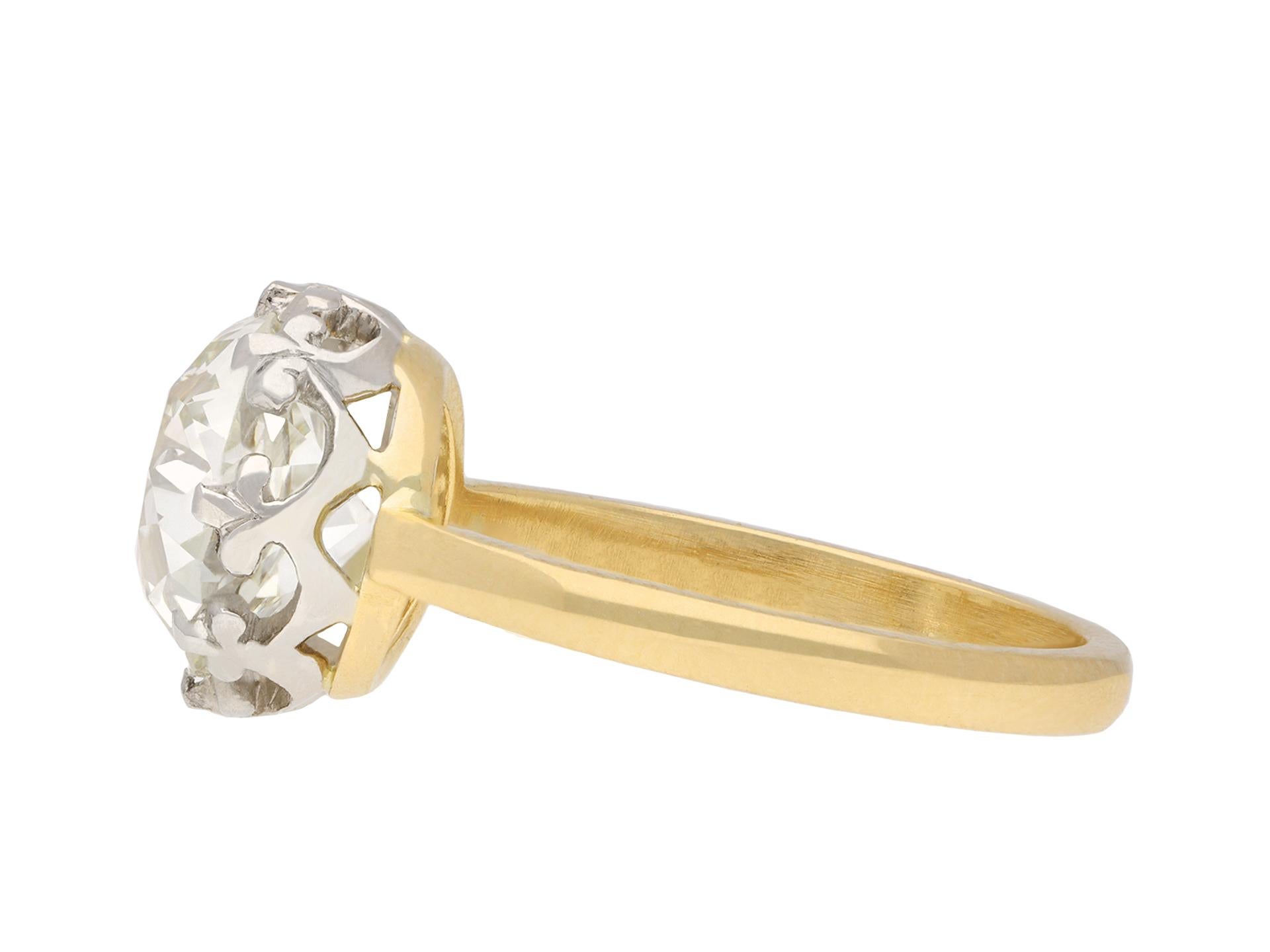 Old mine diamond solitaire ring. Set with a cushion shape old mine diamond, L colour, VS2 clarity, with a weight of 3.35 carats, in an open back claw setting, to an impressive solitaire design featuring curving claws with a fleur-de-lis design, an