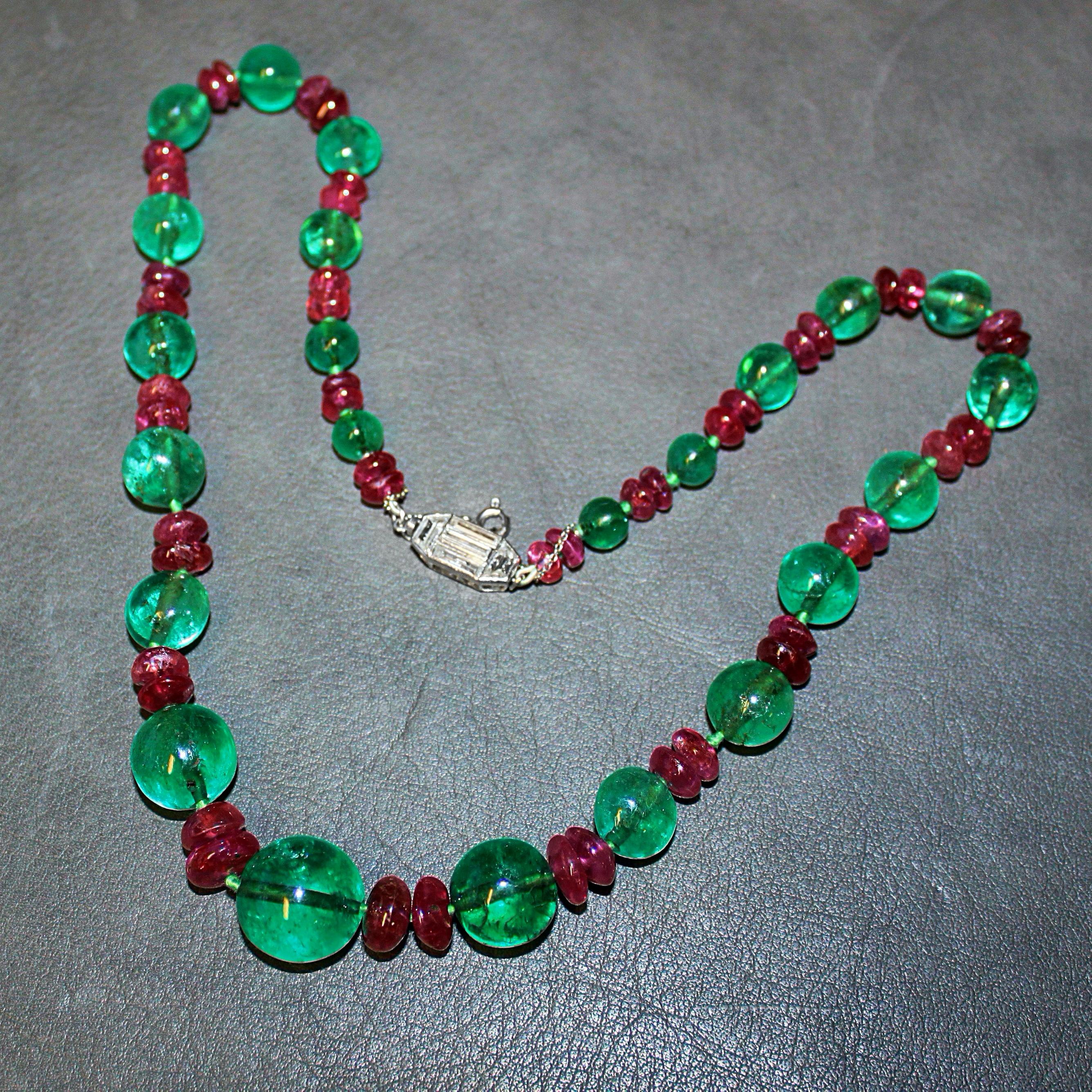 A magnificent French emerald, ruby and diamond Art Deco necklace, ca. 1920s. 

The large old-mine emerald beads have a deep green colour and crystal. They are alternatingly strung next to two old ruby beads in a graduating manner. The clasp at the