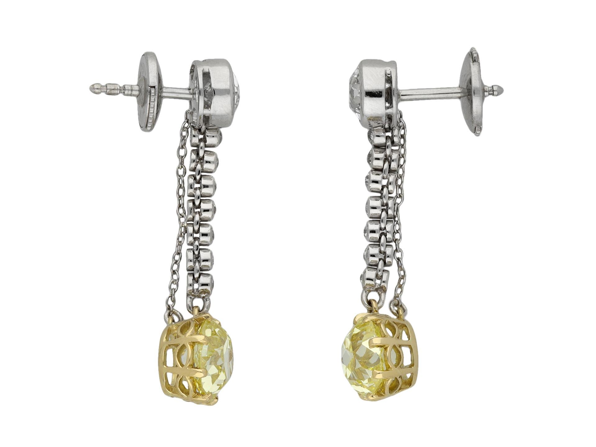 Old mine fancy yellow diamond drop earrings. A matching pair of earrings set to bottom with a cushion shape old mine fancy yellow diamond, one SI1 clarity, approximately 1.40 carats, the other VS2 clarity, 1.62 carats, both set in open back claw