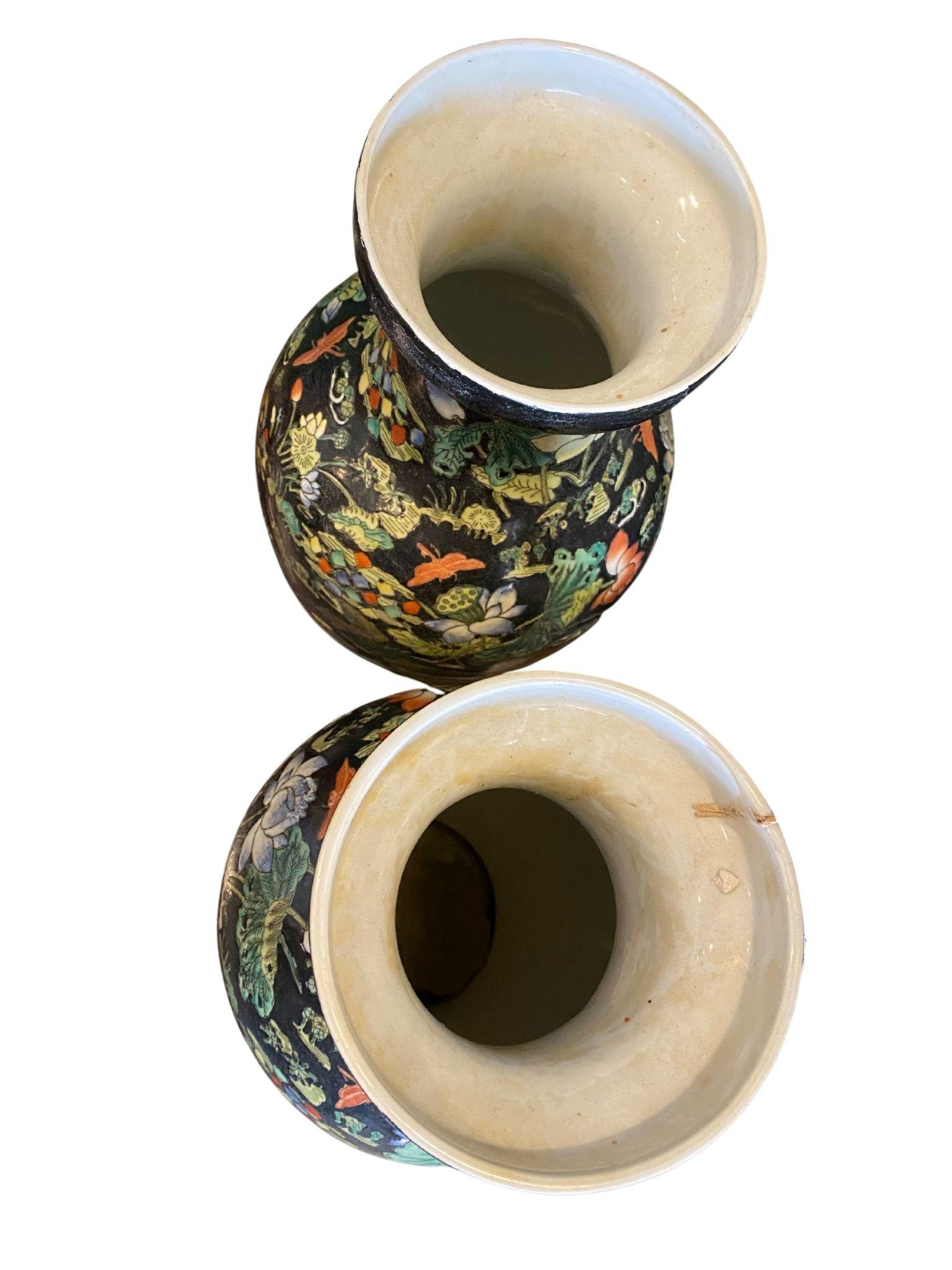 These 1960's Chinese porcelain, hand-painted vases come in a pair.