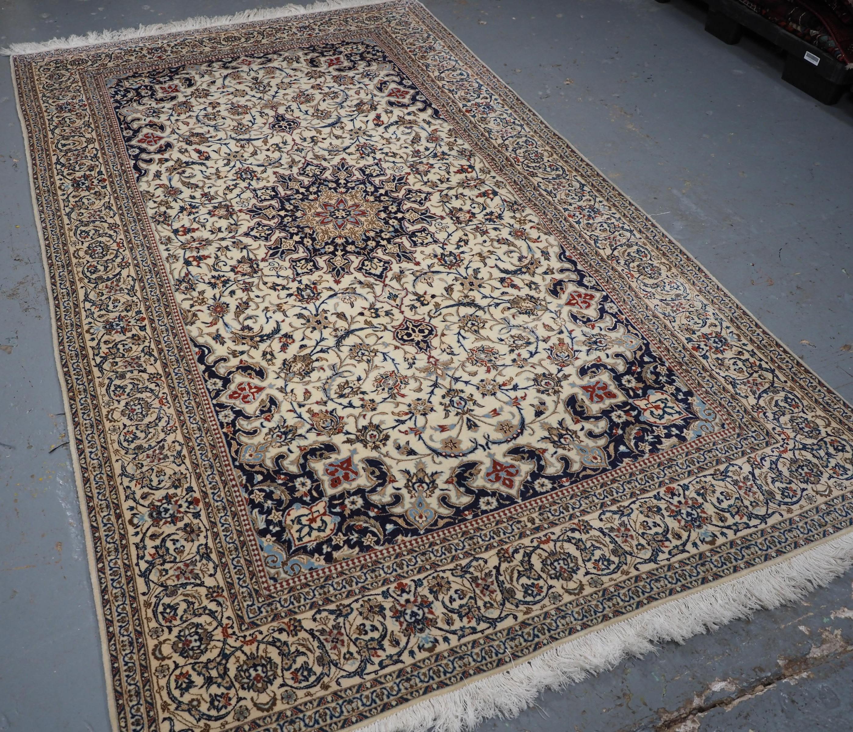 Size: 8ft 5in x 5ft 1in (256x 155cm).

Old Persian Nain carpet, lambs wool and silk on a fine cotton foundation.

Circa 1960.

The carpet is of fine weave with tight fine pile of lambs wool, the carpet has a velvet like feel with highlights in silk.