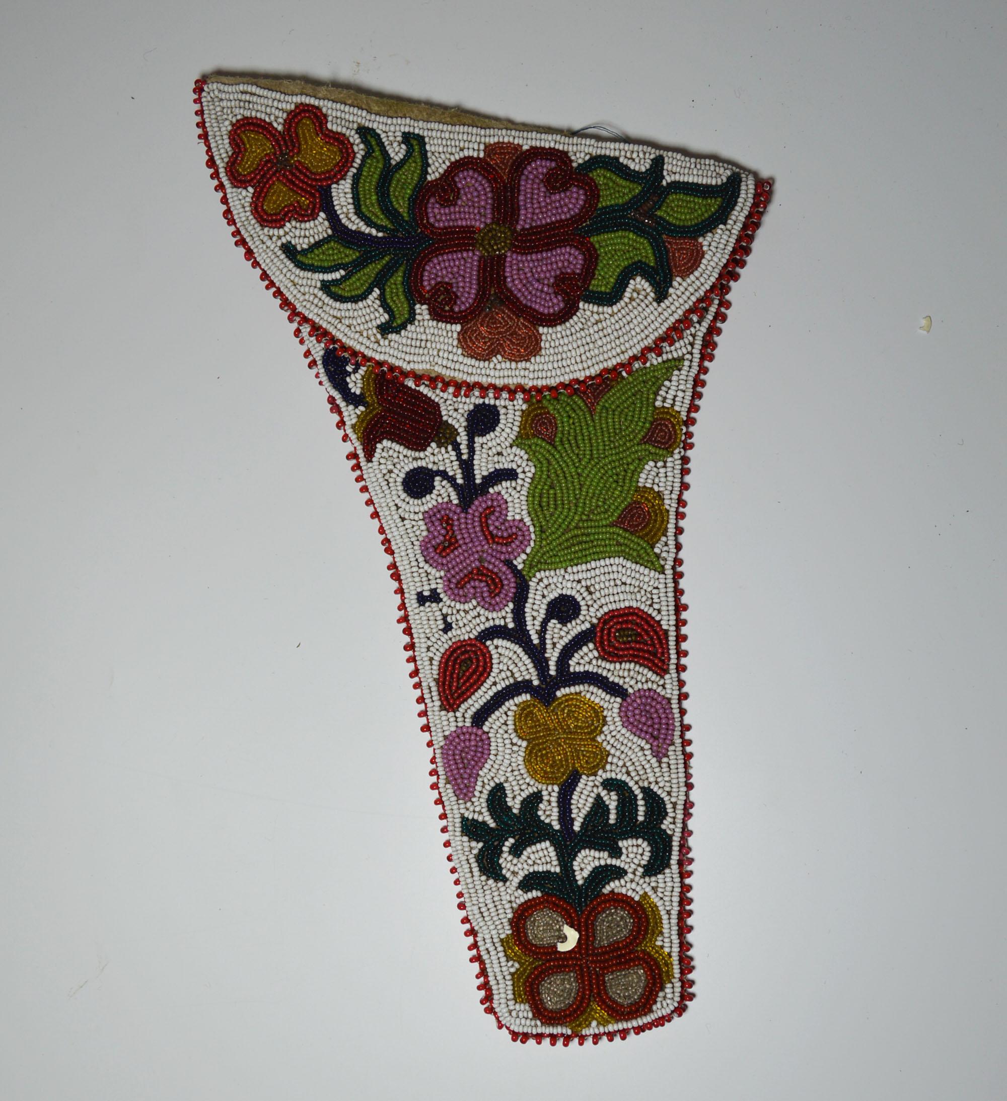A fine old native American Indian Chippewa beaded pistol holster
Buck skin cloth and colored glass beads with white ground and floral decoration
in geometric designs on each side of the bags.
The fringes with red cut beads.
Flap with hook and