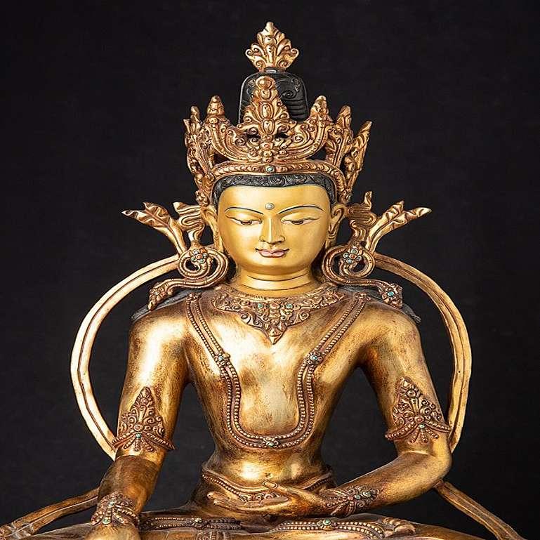 Material: bronze
Measures: 54,5 cm high 
43 cm wide and 34 cm deep
Weight: 14.3 kgs
Fire gilded with 24 krt. gold - the face is traditionally gold painted
Bhumisparsha mudra
Originating from Nepal
Early / middle 20th century
Very high