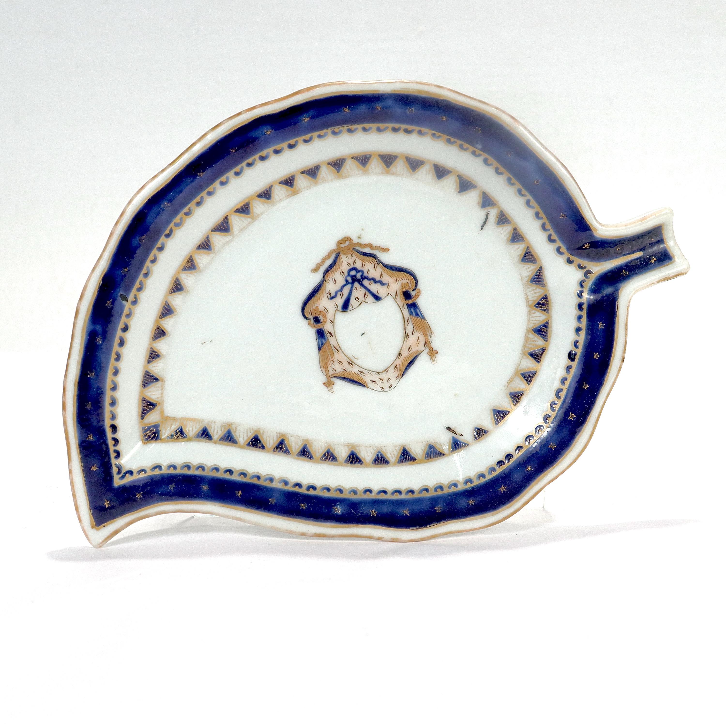 A fine antique Chinese porcelain leaf dish or plate.

In the form of a tobacco leaf with a heraldic crest to the center & colbalt blue decoration with gilt highlights throughout.

Simply a great piece of Chinese Export Porcelain!

Date:
19th