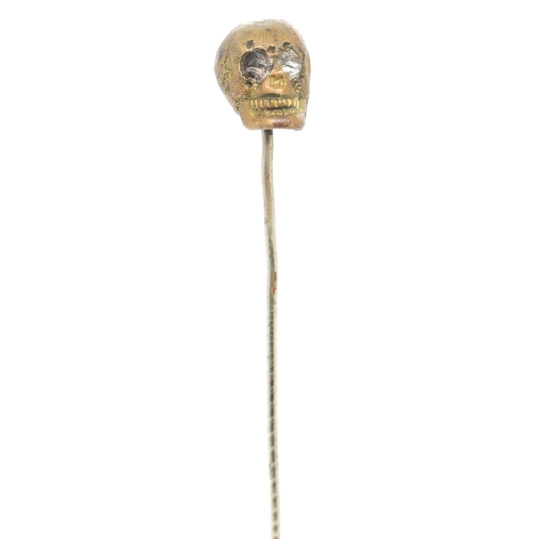 Old or Antique Estate Bronze Skull Memento Mori Stick Pin with Glass Eyes In Good Condition For Sale In Philadelphia, PA