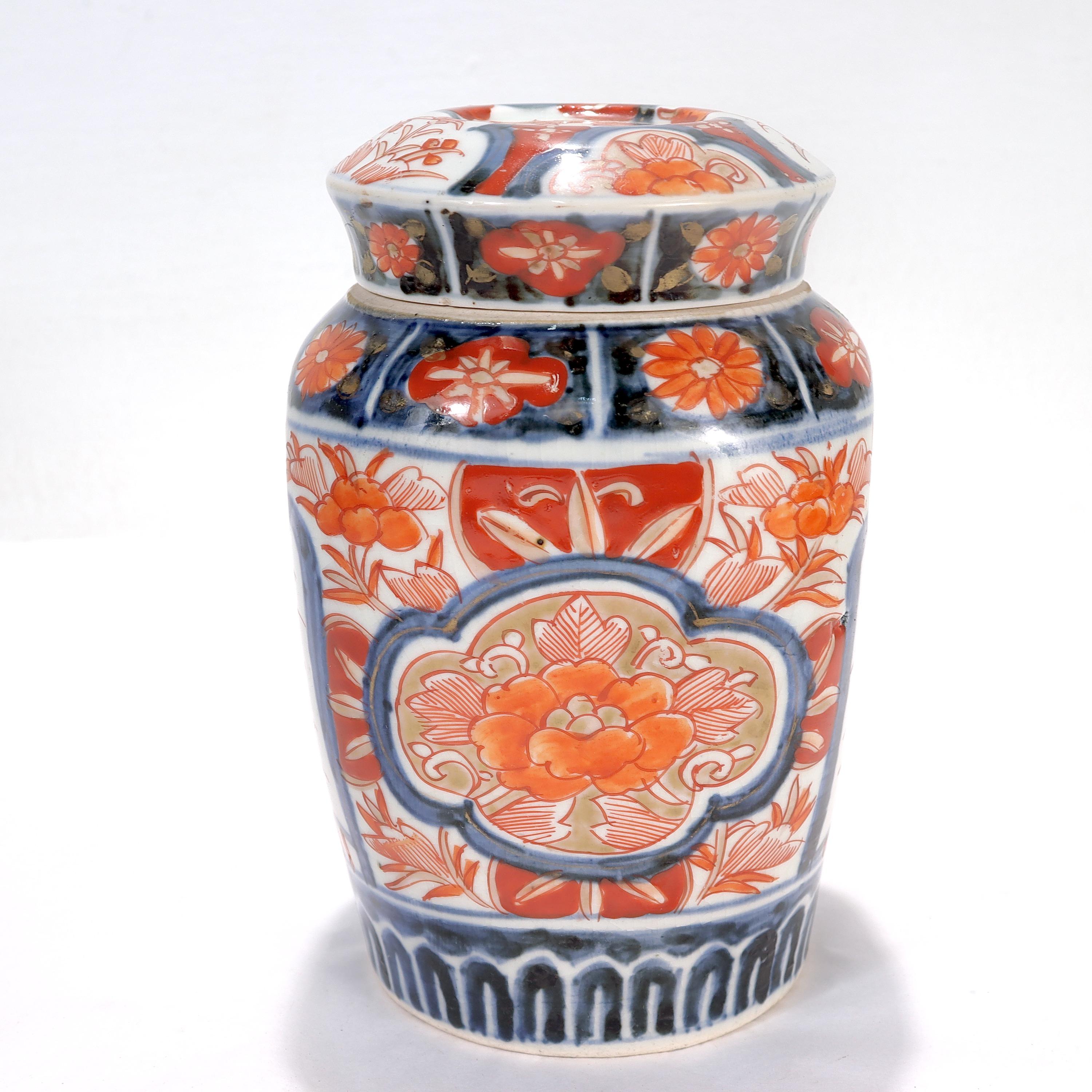 A fine Japanese Imari porcelain lidded jar or urn.

Decorated throughout with painted red floral devices with blue underglaze and gilt highlights against a white ground.

Simply a wonderful Imari porcelain jar!

Date:
20th century or