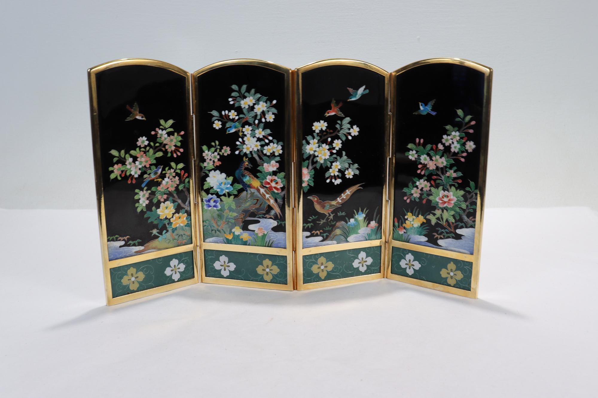 A fine Japanese table screen.

By the Inaba Cloisonne Company. 

One side has polychrome cloisonné enamel depictions of peacocks & other birds gathering among flowers & a stream. The other side is entirely silver plate and has engraved bamboo