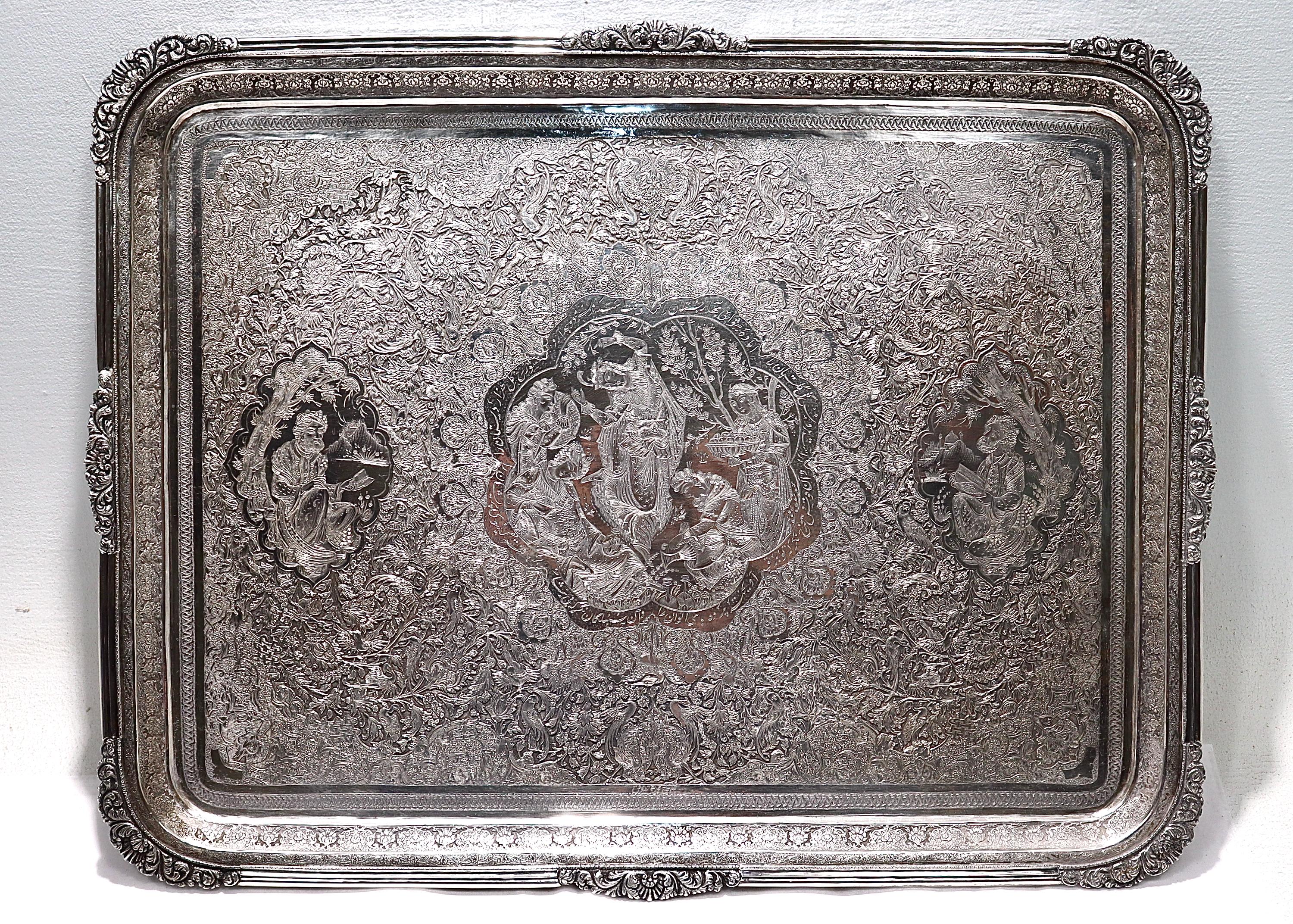 A fine old or antique Islamic silver tray.

With incised & carved decoration throughout including cartouches depicting poets or scholars reading and a festive scene with maidens dancing. 

The central cartouche is encircled with an Arabic