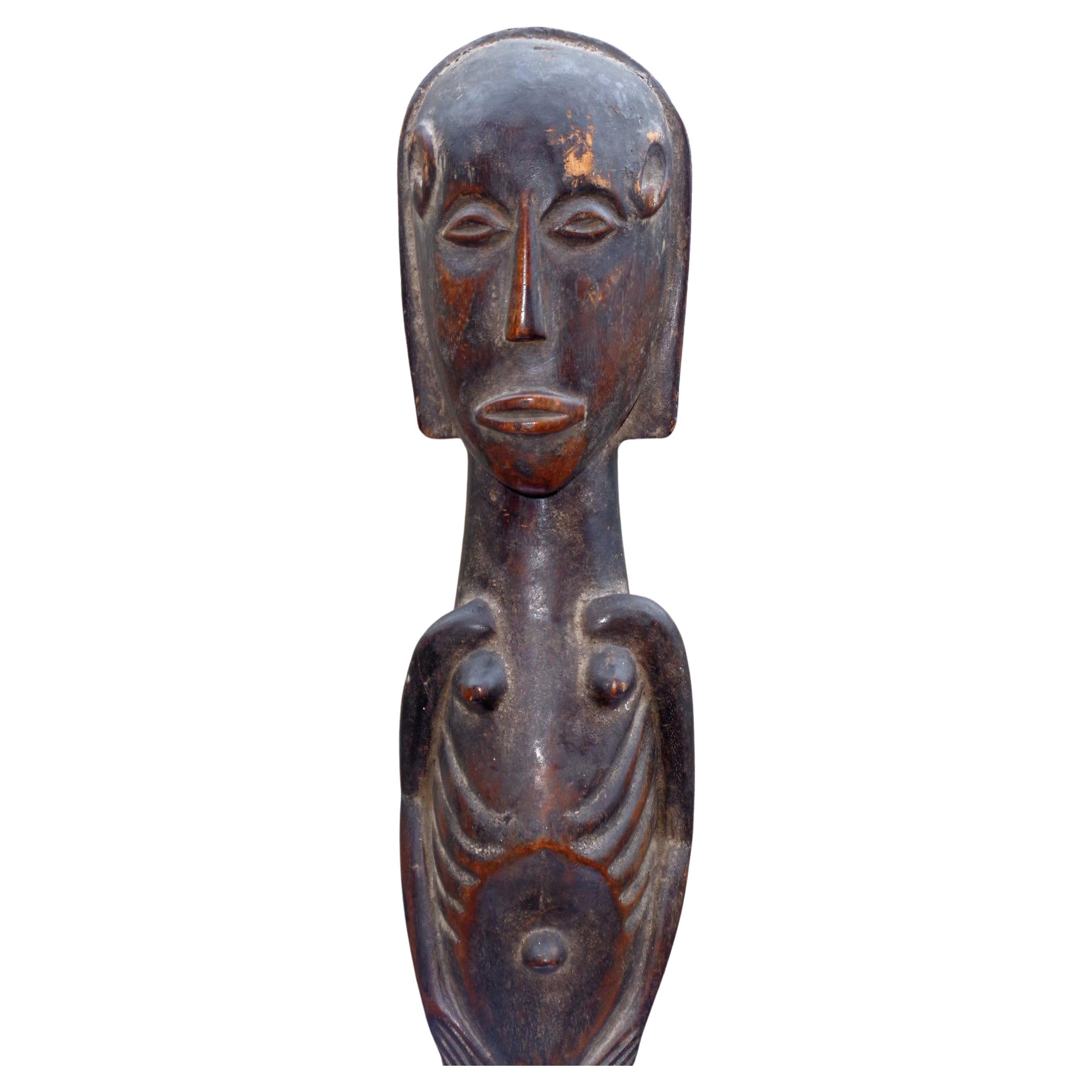  Oceanic islands carved hardwood standing male figure  w/ finely detailed anatomical features and beautifully aged surface color wear patina. Selling w/ a custom iron stand as shown in primary image. Circa mid 20th century. Look at all pictures and