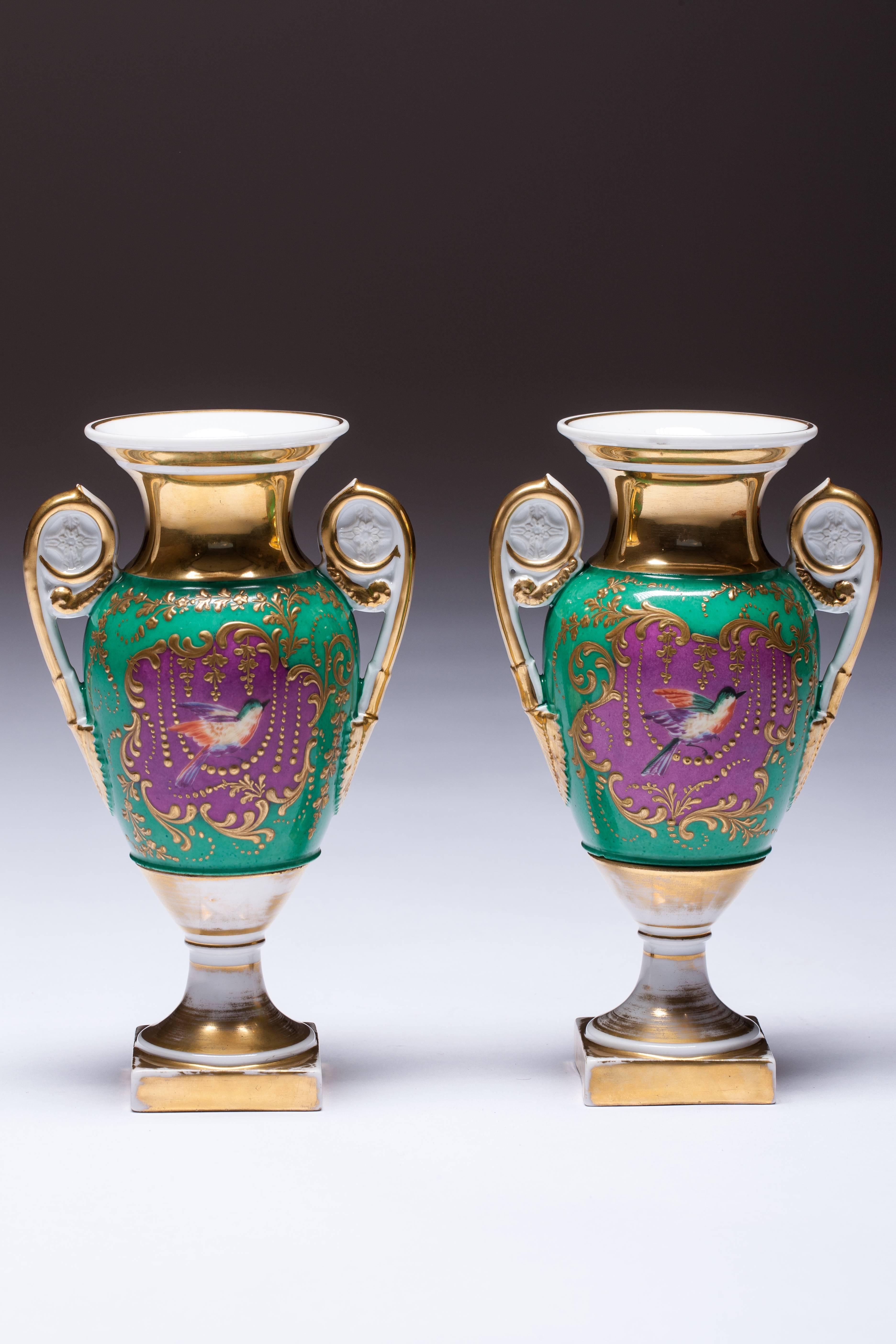 Especially rare vases decorated with hand-painted bird pink background. A beaded ornament around it, for which the green background is framed. The vases are dipped in porcelain biscuit and gold in the same way as the whole vase.
 