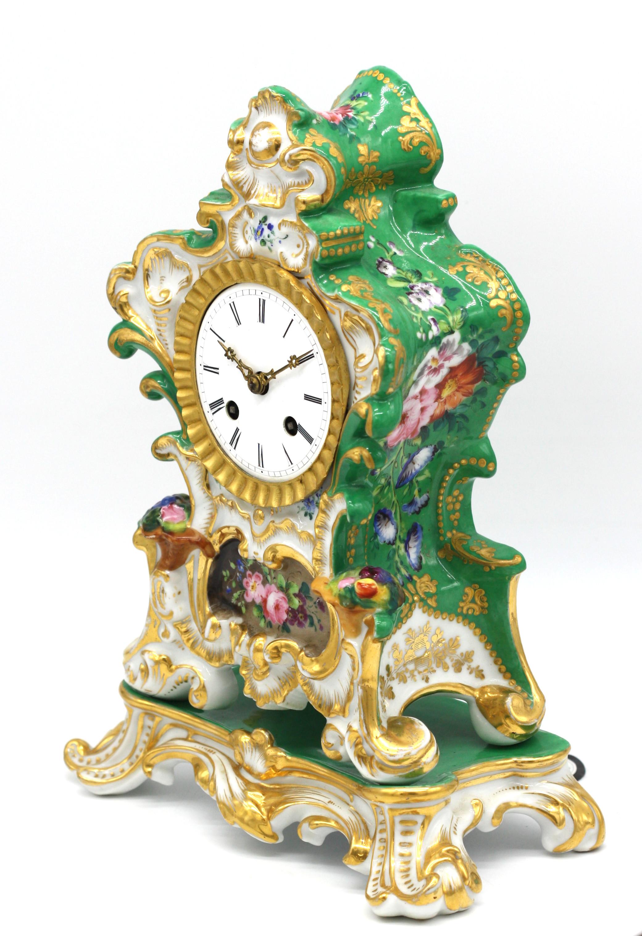 Old Paris porcelain mantel clock and stand,
French. Late 19th century.
Movement stamped 
Raingo Fres Paris
The circular dial with Roman numerals housed within the scroll case, on a conforming stand.
Measures: height 10.75 in. (27.30 cm.), width
