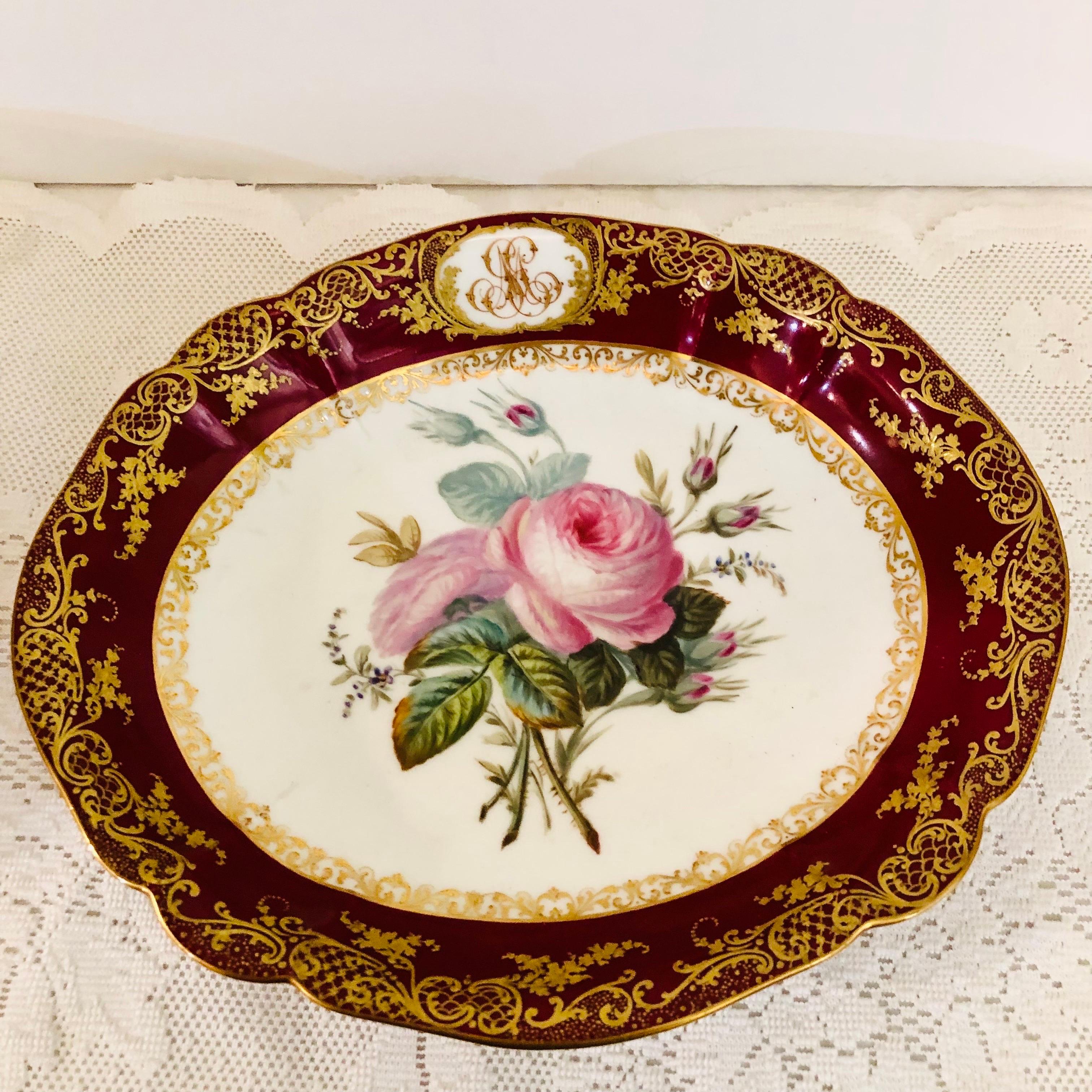Look at the museum quality painting of roses on this Old Paris Porcelain bowl painted by the studio of Boyer Rue De La Paix. This bowl was made in the mid 19th century. The central painting of roses is surrounded by a maroon, red fluted border with