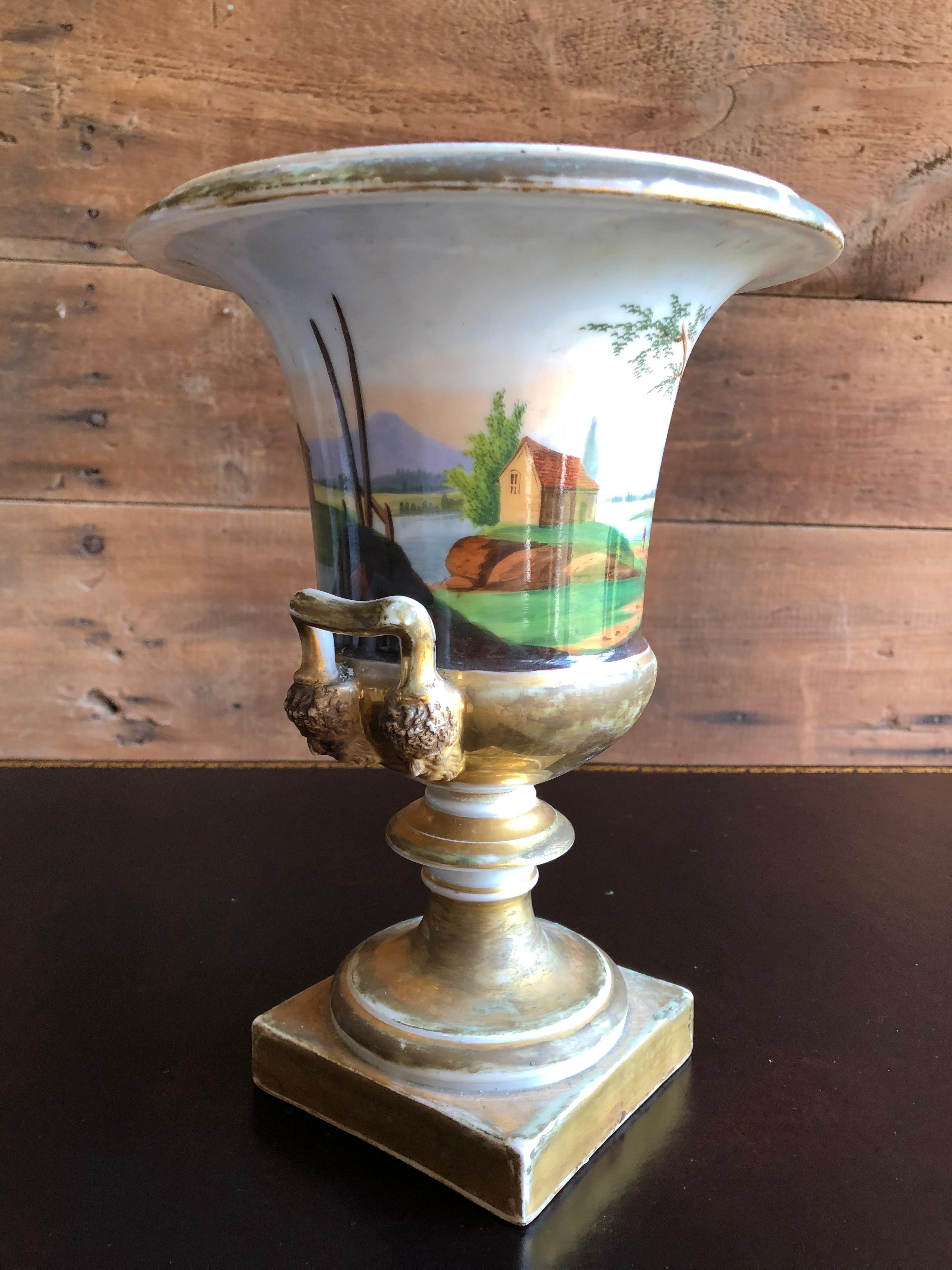 A large and nice old Paris porcelain urn-form vase with idyllic landscapes and traces of old gilding.