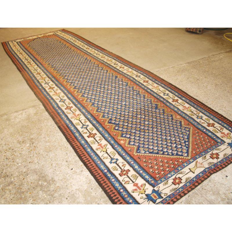 Old Persian Bijar kilim of large size and traditional design.

A very pleasing example with an all over design on a indigo blue field . The kilim has a soft colour palette.

Excellent condition with very slight even wear.

A strong kilim suitable