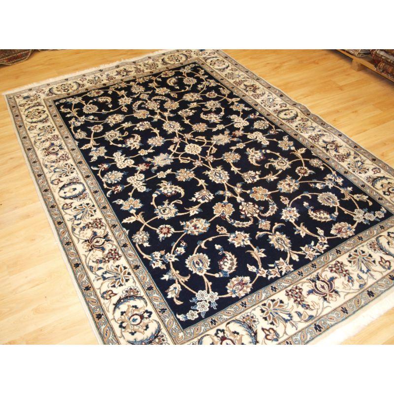 Old Persian Nain rug, lambs wool on a fine cotton foundation.

The rug is of fine weave with tight fine pile of lambs wool, the carpet has a velvet like feel.

The rug has a floral design with fine detail in soft pastel colours on a midnight