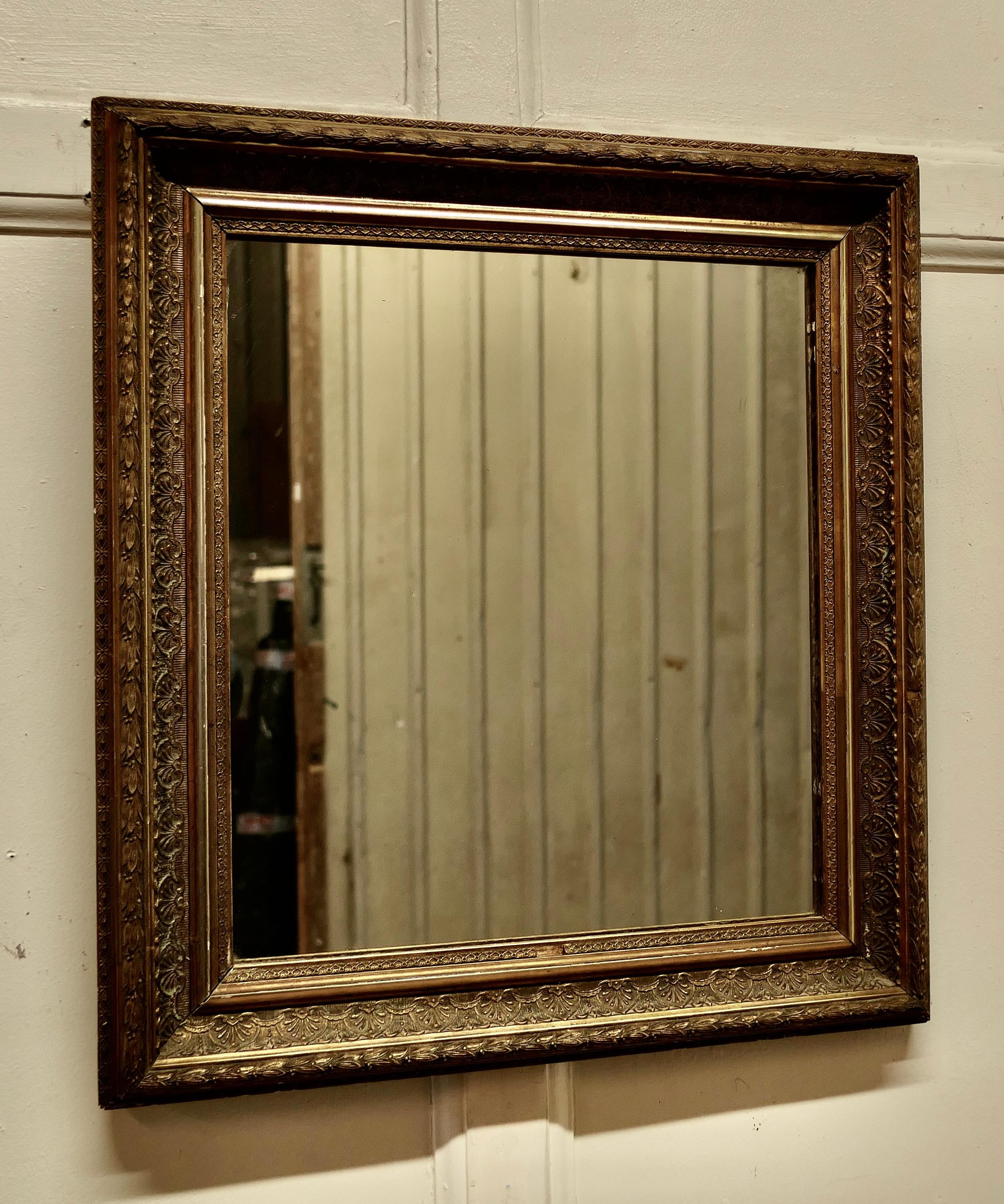 Old Rectangular Gilt mirror

The mirror has a lovely age darkened decorative Gilt frame, it is almost square
The mirror is in good Vintage condition there is one minor loss at the bottom of the frame
A lovely Piece
The Mirror is 21”x 19” and 3”