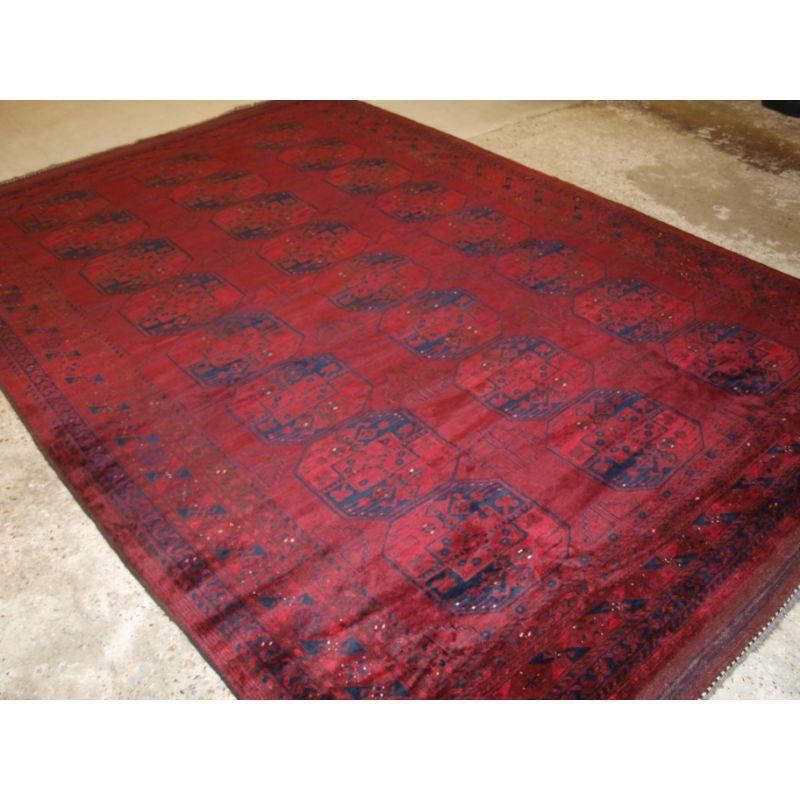 Old Red Afghan carpet with traditional design, this carpet has superb colour with a very good deep rich red and a deep indigo blue. The carpet retains the original flat woven kilim end finishes at both ends.

The carpet is in excellent condition