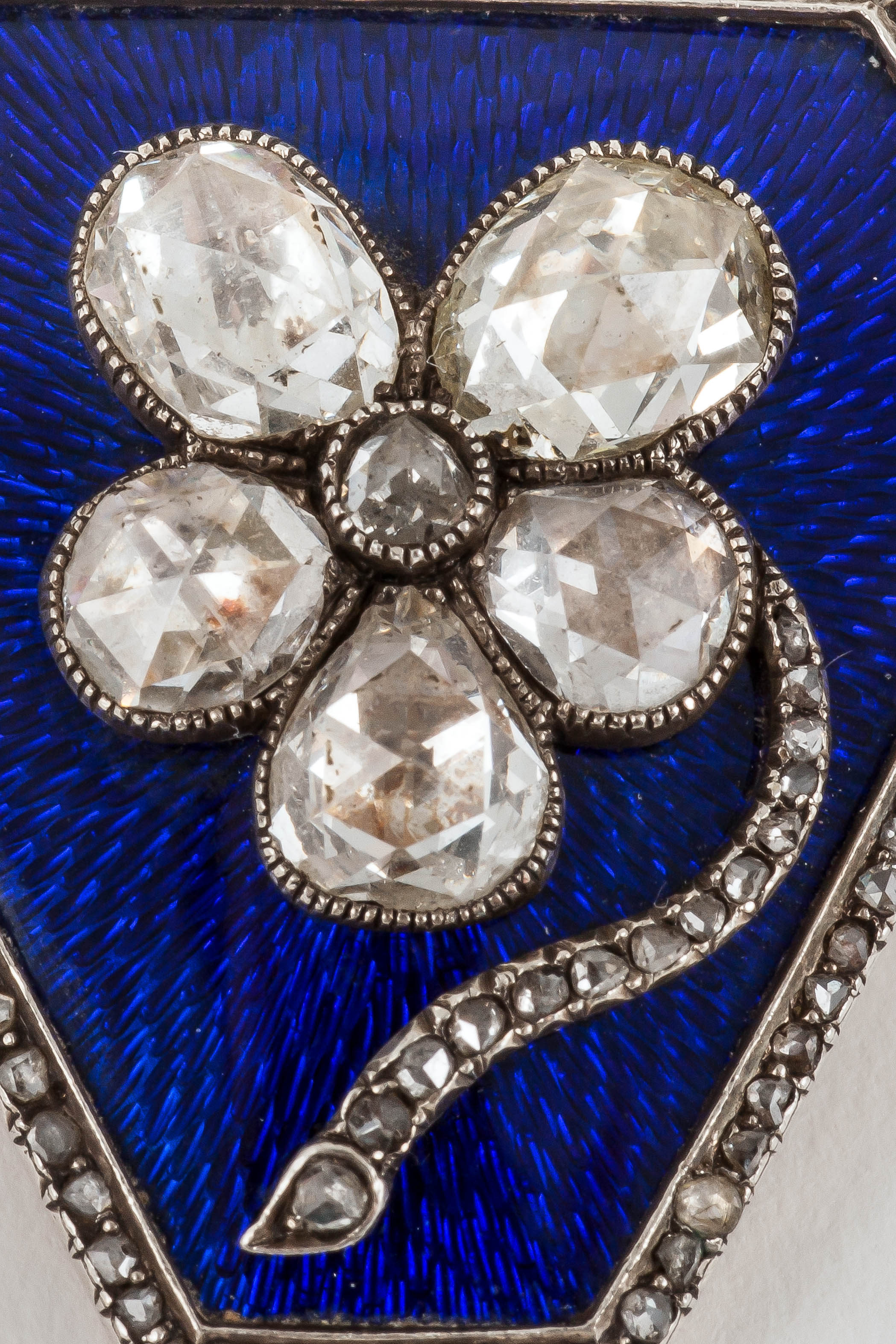 14 karat yellow gold and silver mounted Russian brooch of fine quality and condition. With crown rose cut diamonds in the centre in the form a pansy on a blue enamel background and a rose-cut diamond border. The back of the brooch is engraved with