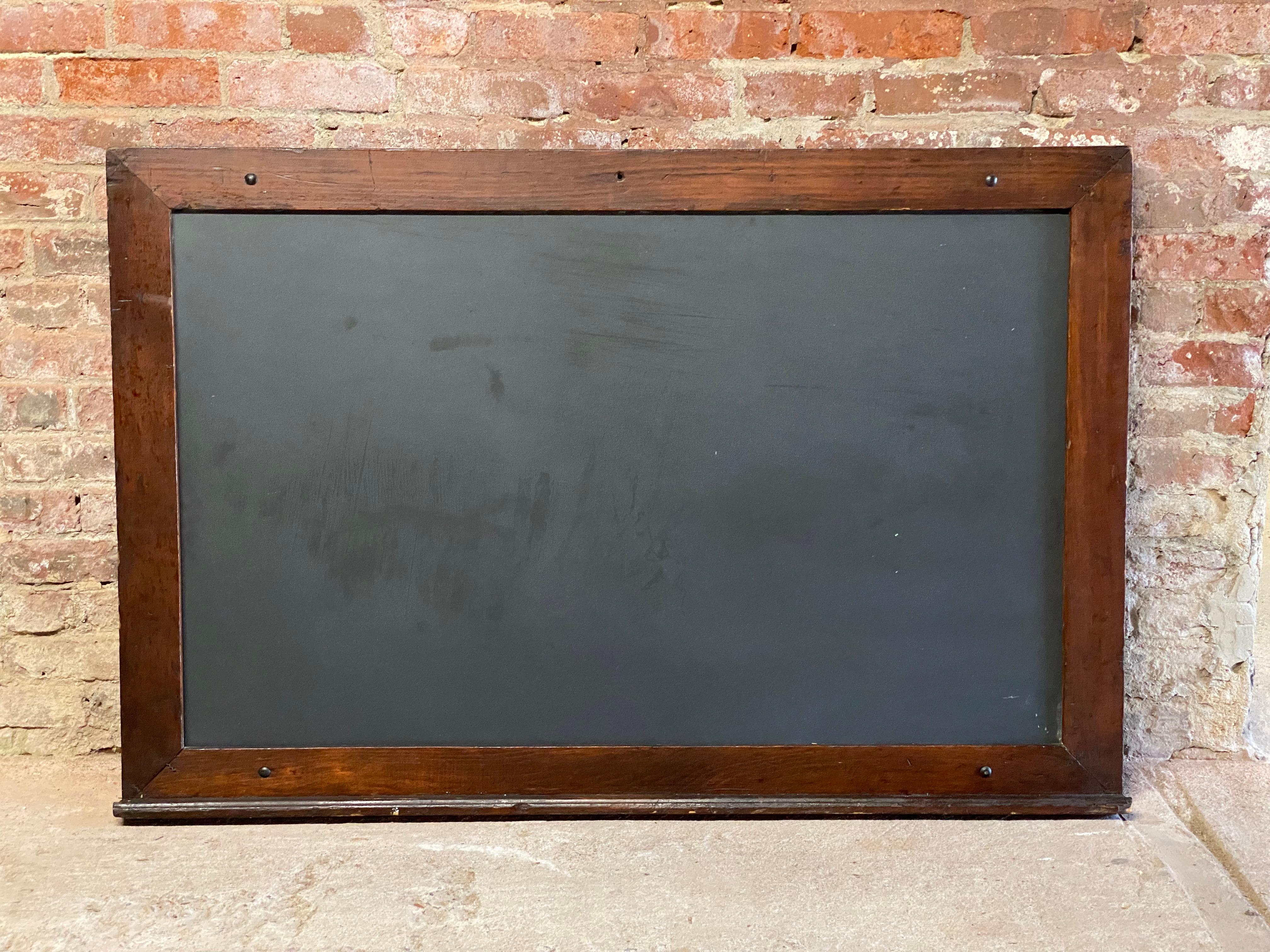 Large old schoolhouse slate blackboard. Circa 1900-30. Just the right size for the home, restaurant, bar or office. Not too big, not too small. The thick hand hewn slate board is framed in a soft wood like pine or birch. Nice corrugated metal spline