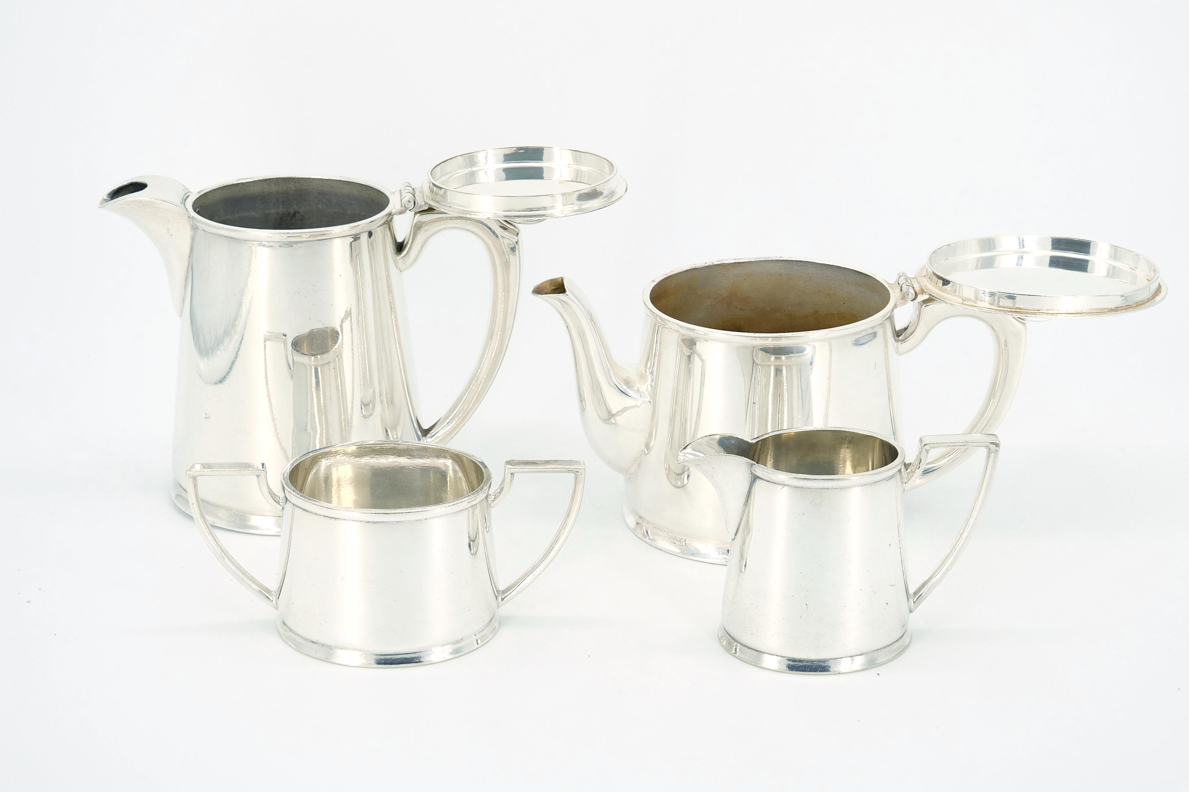 Indulge in the timeless elegance of this Edwardian-period English silver-plate four-piece tea and coffee service, crafted with clean lines in the sophisticated Art Deco style by the renowned Walker and Hall of Sheffield. This exquisite set adds a