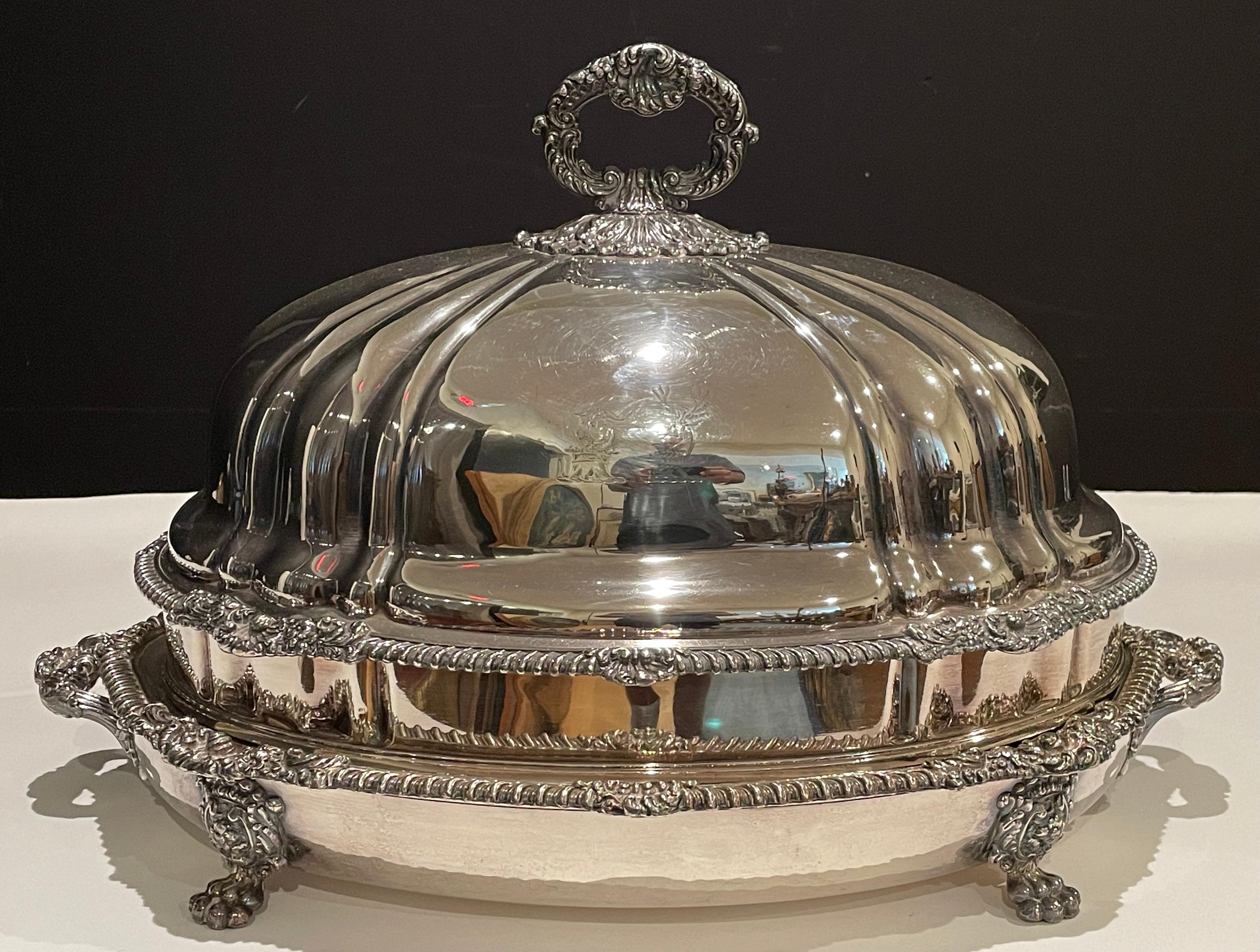 Lamb and venison meat dish is masterfully crafted of fine Old Sheffield silver plate. This dish is crafted with the utmost intricacy in a manner one would expect from a sterling counterpart. The rich leaf motif extends from the scrolling feet and