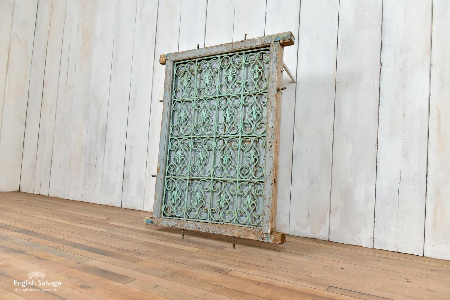 Charming old Moroccan window with wrought iron front grille and wooden shutters. Shabby paint and the shutters need some attention at the joints. The overall size of the window is 69cm wide and 100cm high. This measurement excludes the metal pins at