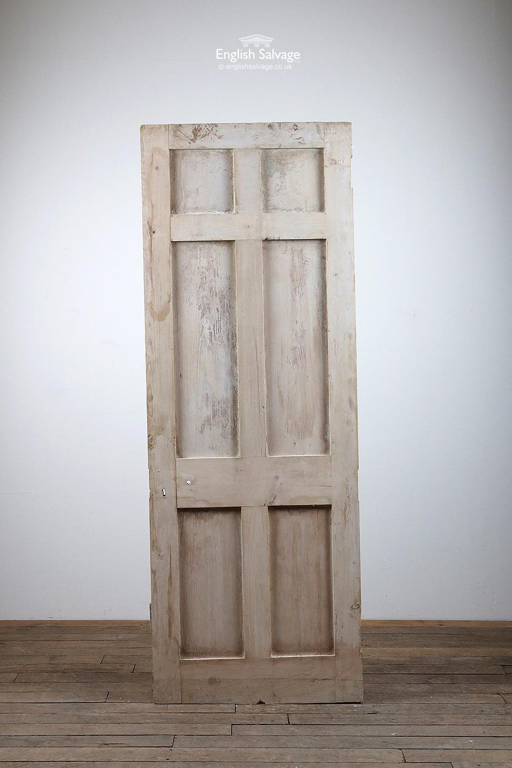 Reclaimed six panel pine door, plain both sides. Has been cut on a slant, the height varies from 194cm-195.5cm. Old fitting holes, hinge cut outs. Door has been partly stripped, some traces of paint remain.