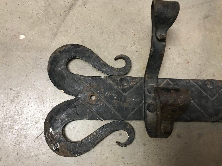 A pair of wall hung racks that could be used to hang coats, towels by the pool, bridles in the barn or just about anything else. The hand wrought technique along with the great patina makes them very desirable.