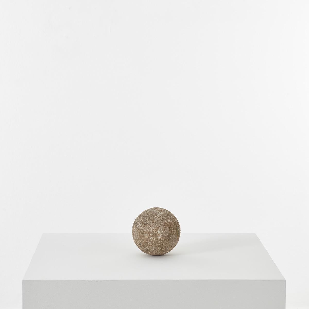 This old finial ball ornament had been carved from a single piece of Granite stone. The surface across its spherical form shows a pleasing texture that is rough to the touch. In good structural condition, with signs of past use.