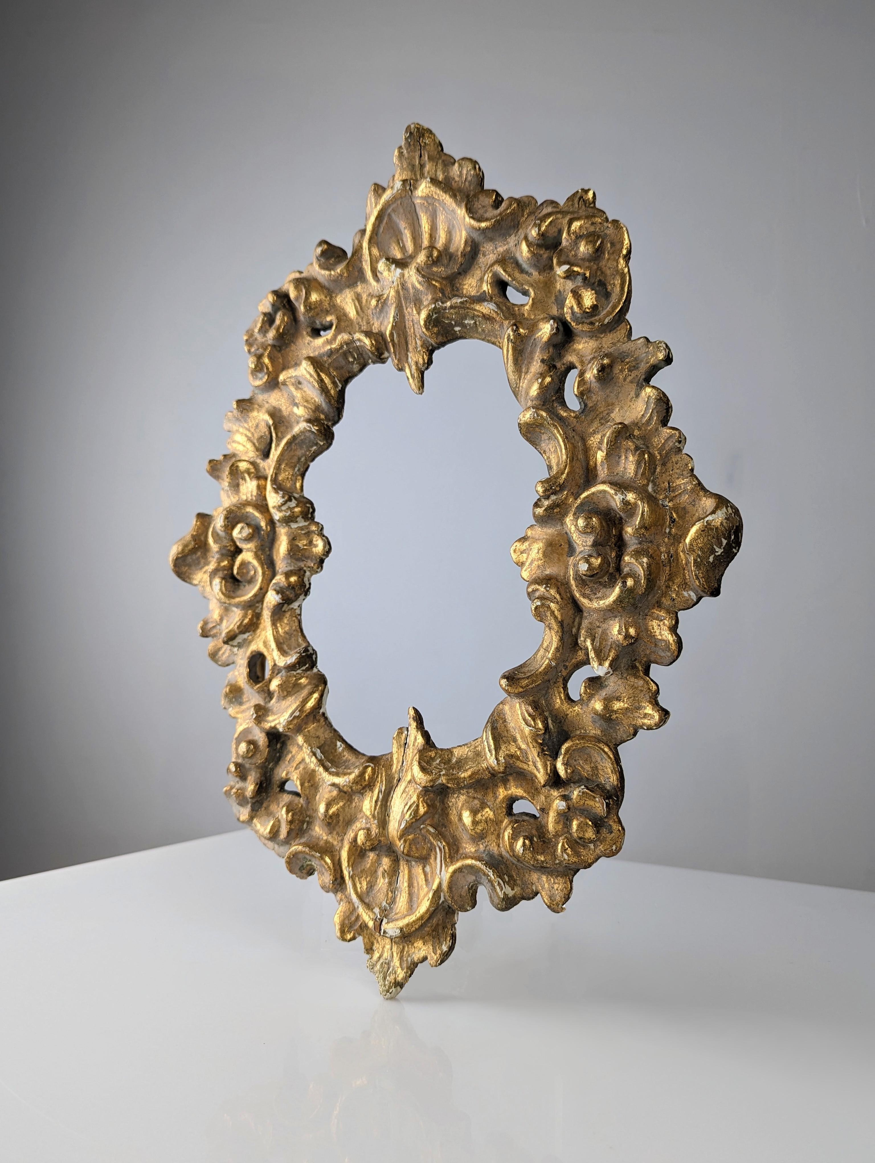 Elevate the elegance of any space with this magnificent golden stuccoed wooden frame with beautiful floral details, this frame captivates thanks to its age and golden patina, with its soft wear and some cracks that adds authenticity and character,