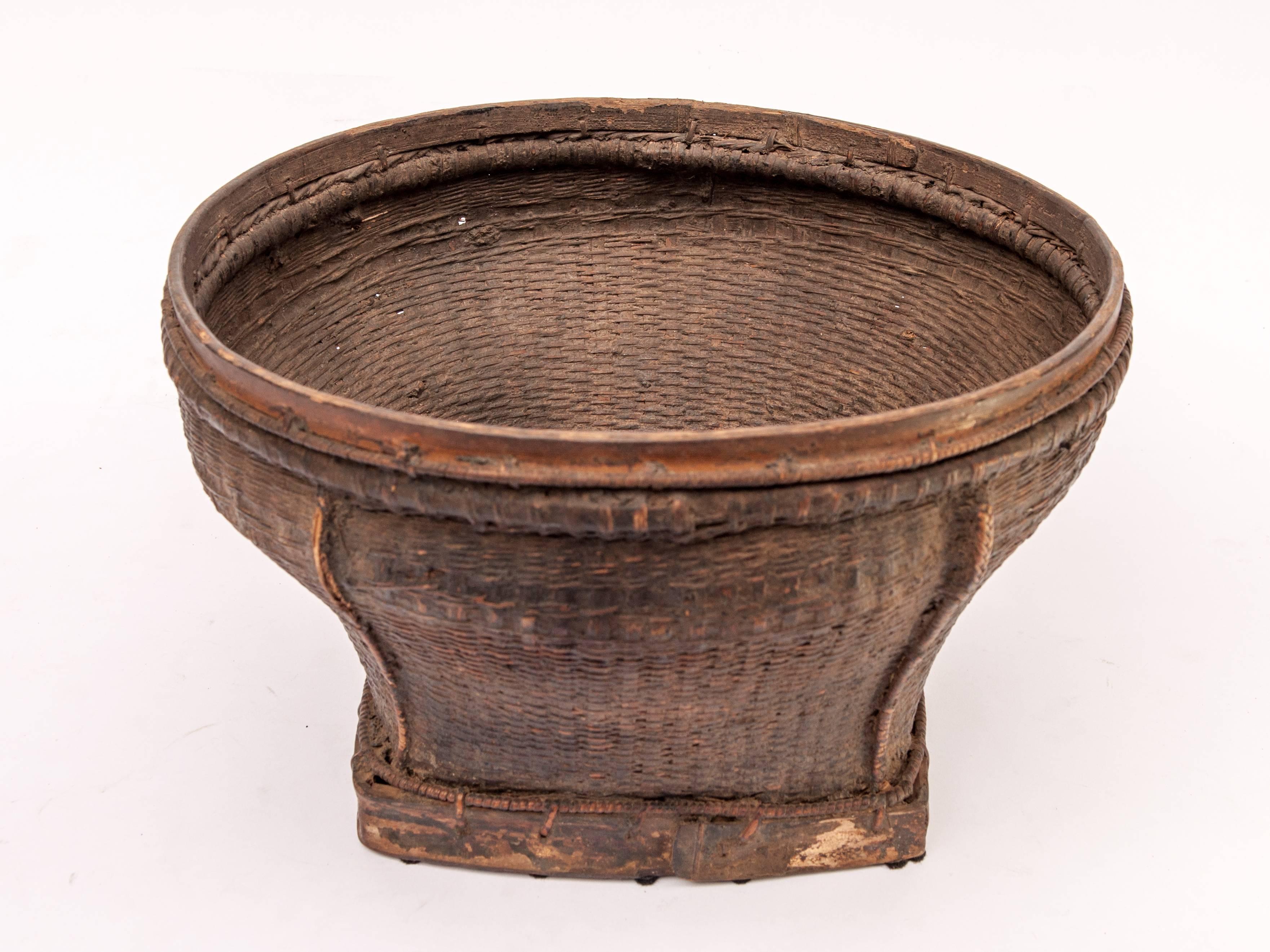 Old tribal market basket from Cambodia, mid-20th century
This is a rustic yet surprisingly graceful basket, very strongly made and used to transport and display market goods for selling. There are some minor original repairs, using cloth, in the