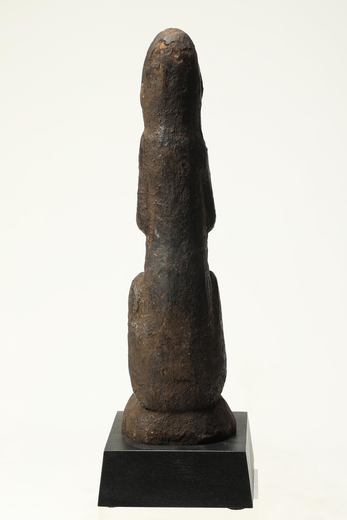 Old Tribal stone squatting spring figure with hands raised in namaste position, traces of clay and incrustation, expressive carved face. These were protective figures used in Nepal. Late 19th to early 20th century, 12 3/4 inches high. On solid