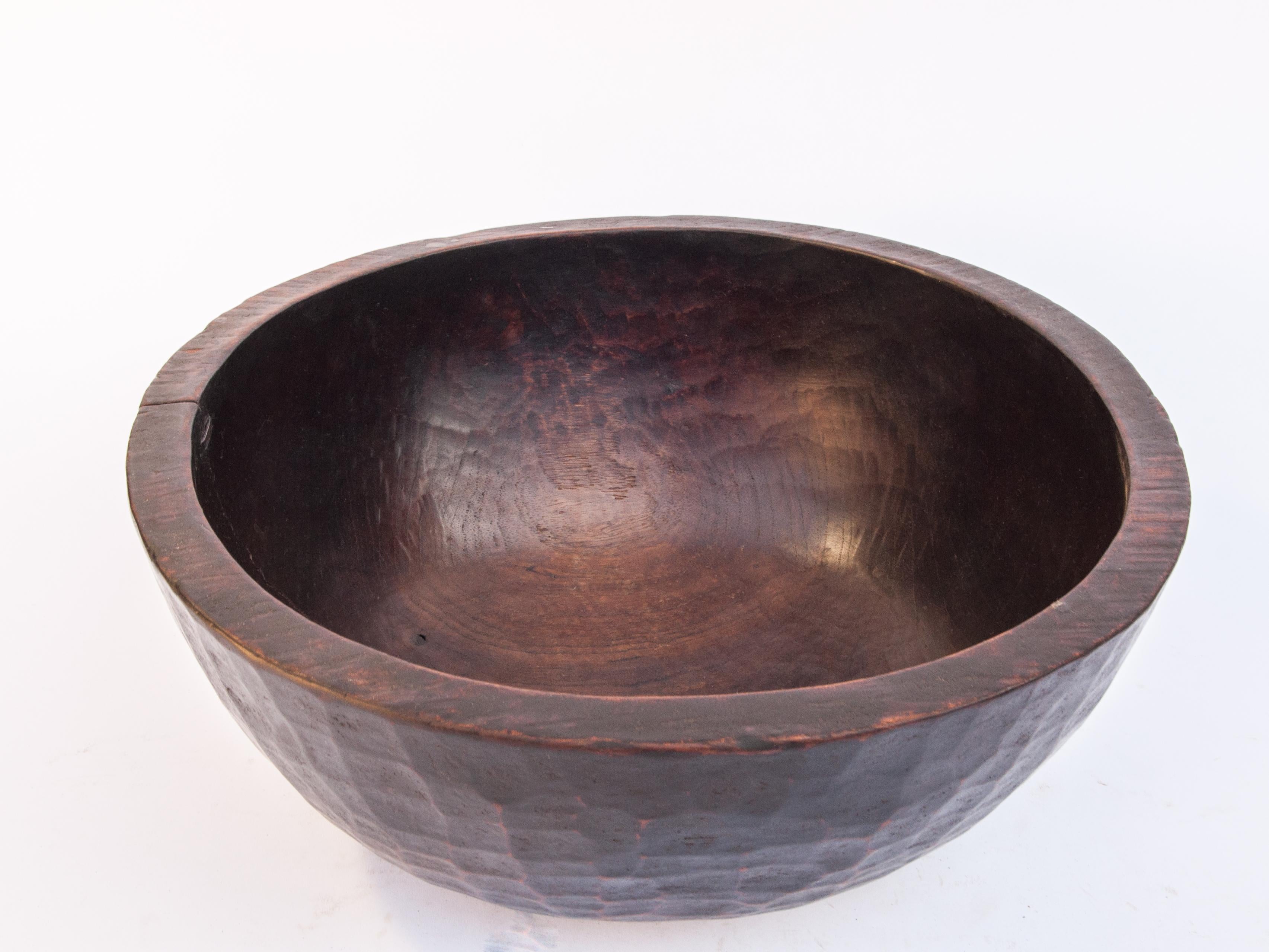 Old tribal wooden bowl, West Nepal Himal, mid-20th century. Measures: 16.5 inch diameter.
This large bowl is hand hewn from a single piece of local wood. Years of use in the rugged conditions of a west Nepal household, and exposure to household