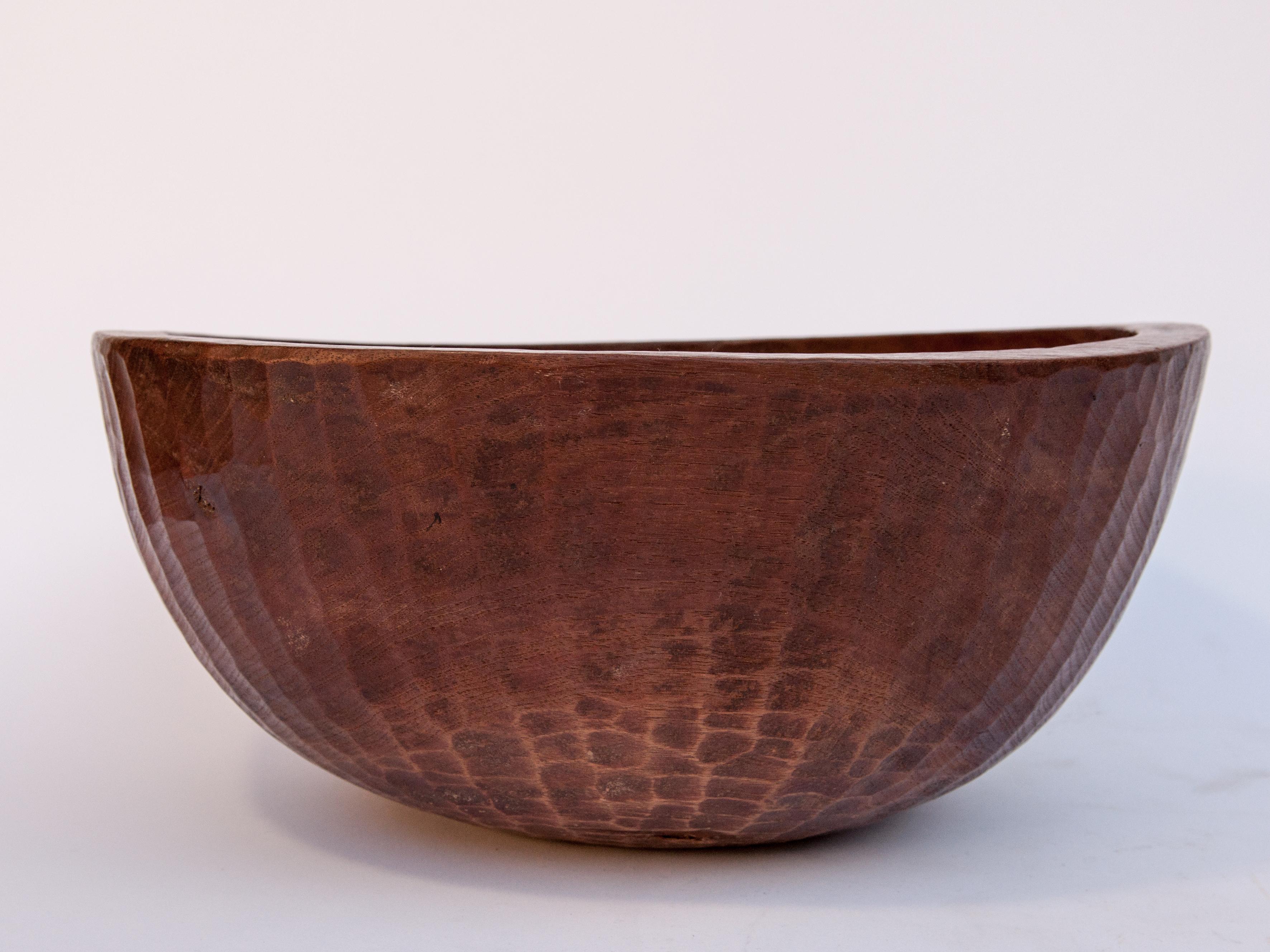 Old tribal wooden bowl from West Nepal Himal, 14.25 inch diameter, mid-20th century
This bowl is hand hewn from a single piece of local wood. It has a rich patina, a lovely grain pattern in the wood, and the hand adzed shaping of the bowl has given