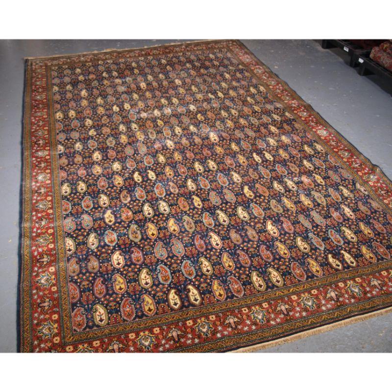 Old Turkish Hereke carpet, wool pile on a wool foundation.

The carpet is beautifully drawn with a all over small boteh design on a indigo blue background. The boteh are in a range of soft pastel colours giving the carpet a lighter feel.

The