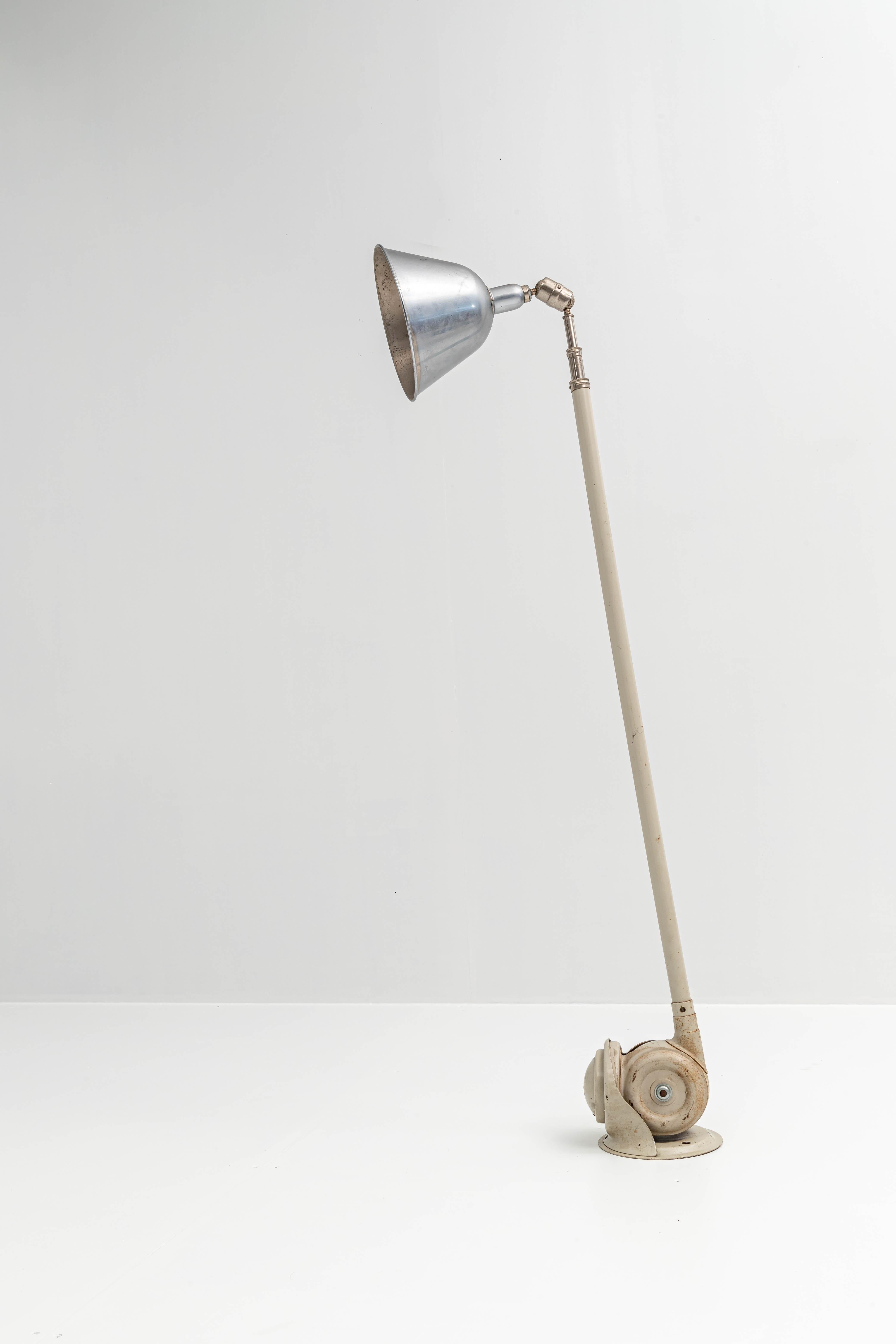 Old version floor- or wall lamp by Petter Johansson with metal shade, beautifully patinated and in perfect working condition. The metal of the lamp is grey lacquered and it is telescopic until 300 cm which makes it pretty large. The metal